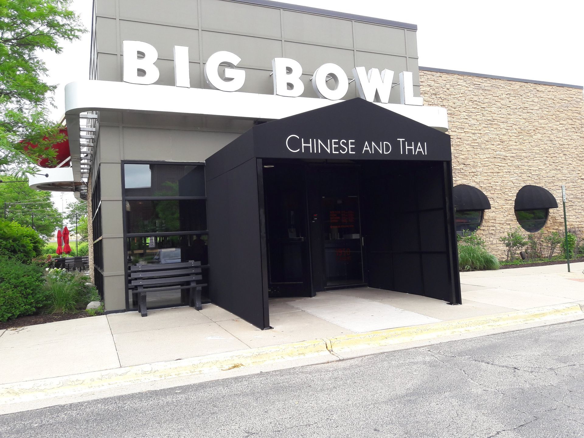 The big bowl chinese and thai restaurant has a black awning over the entrance.