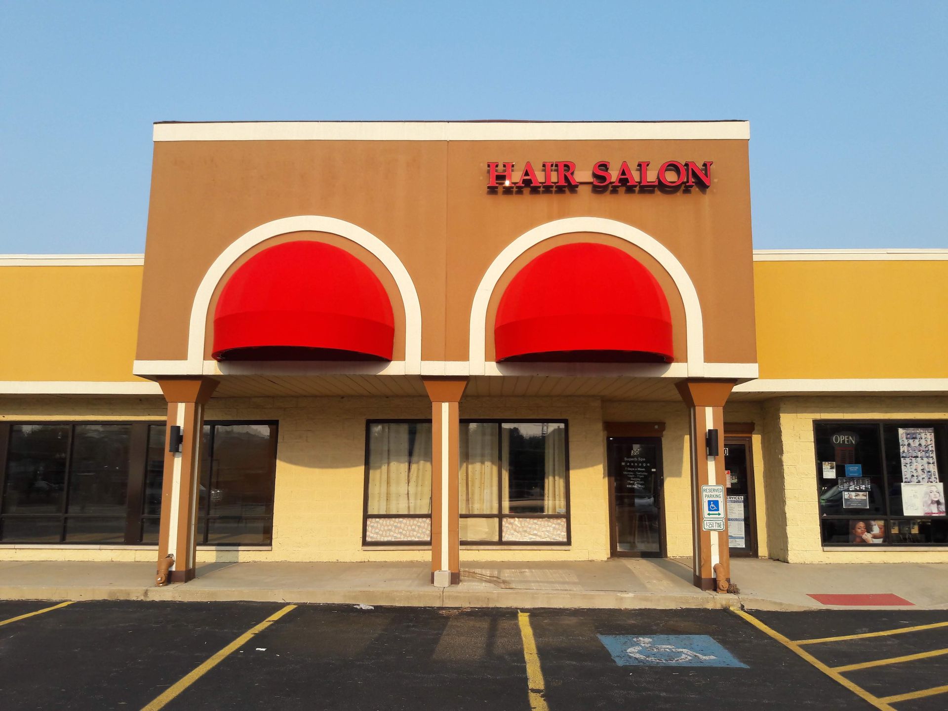 The front of a hair salon with a red awning