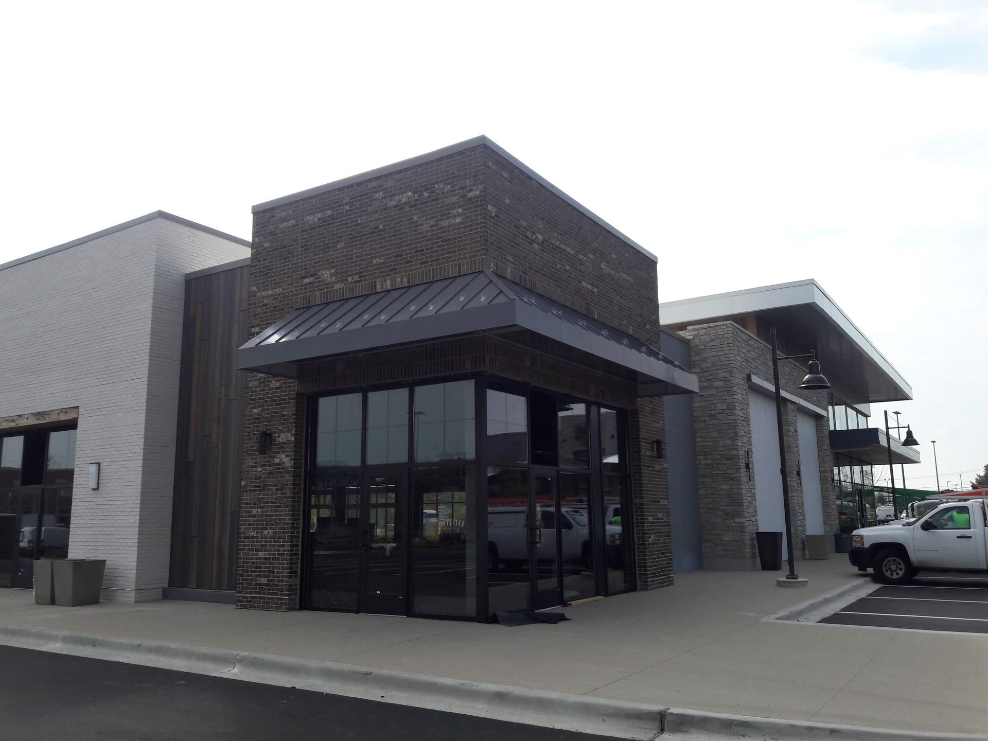 A white truck is parked in front of a building.