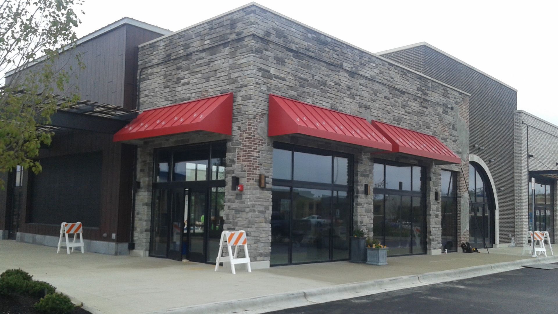 A building with a red awning on the side of it