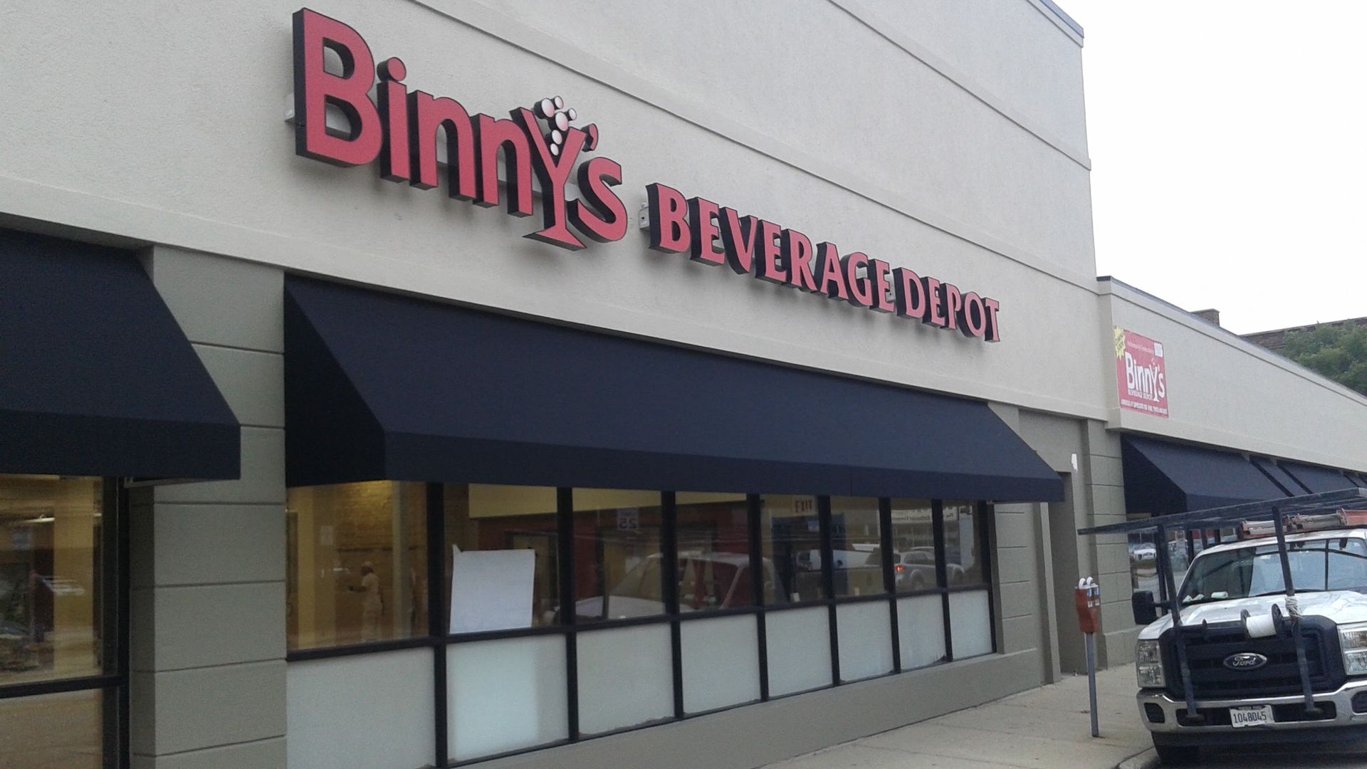 Binny 's beverage depot has a truck parked in front of it