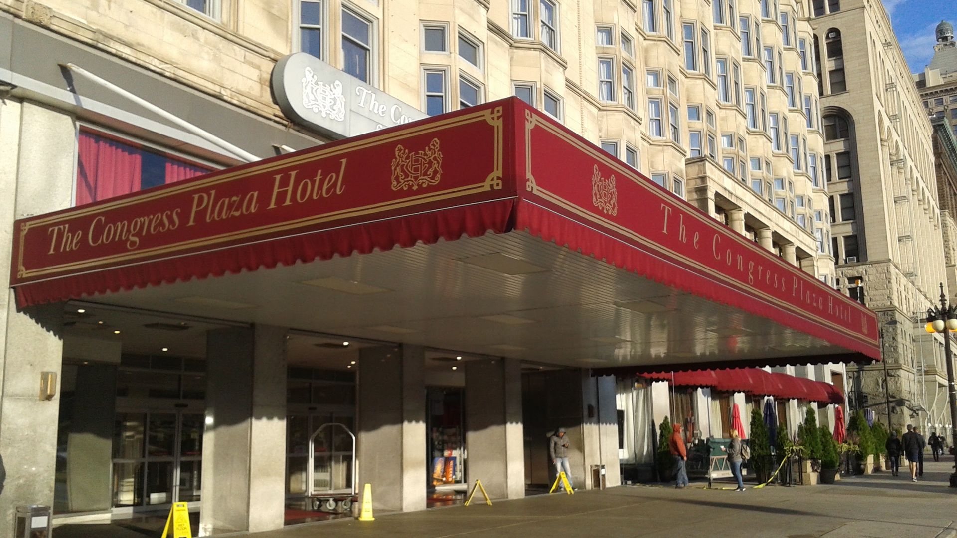 The congress plaza hotel has a red awning over the entrance