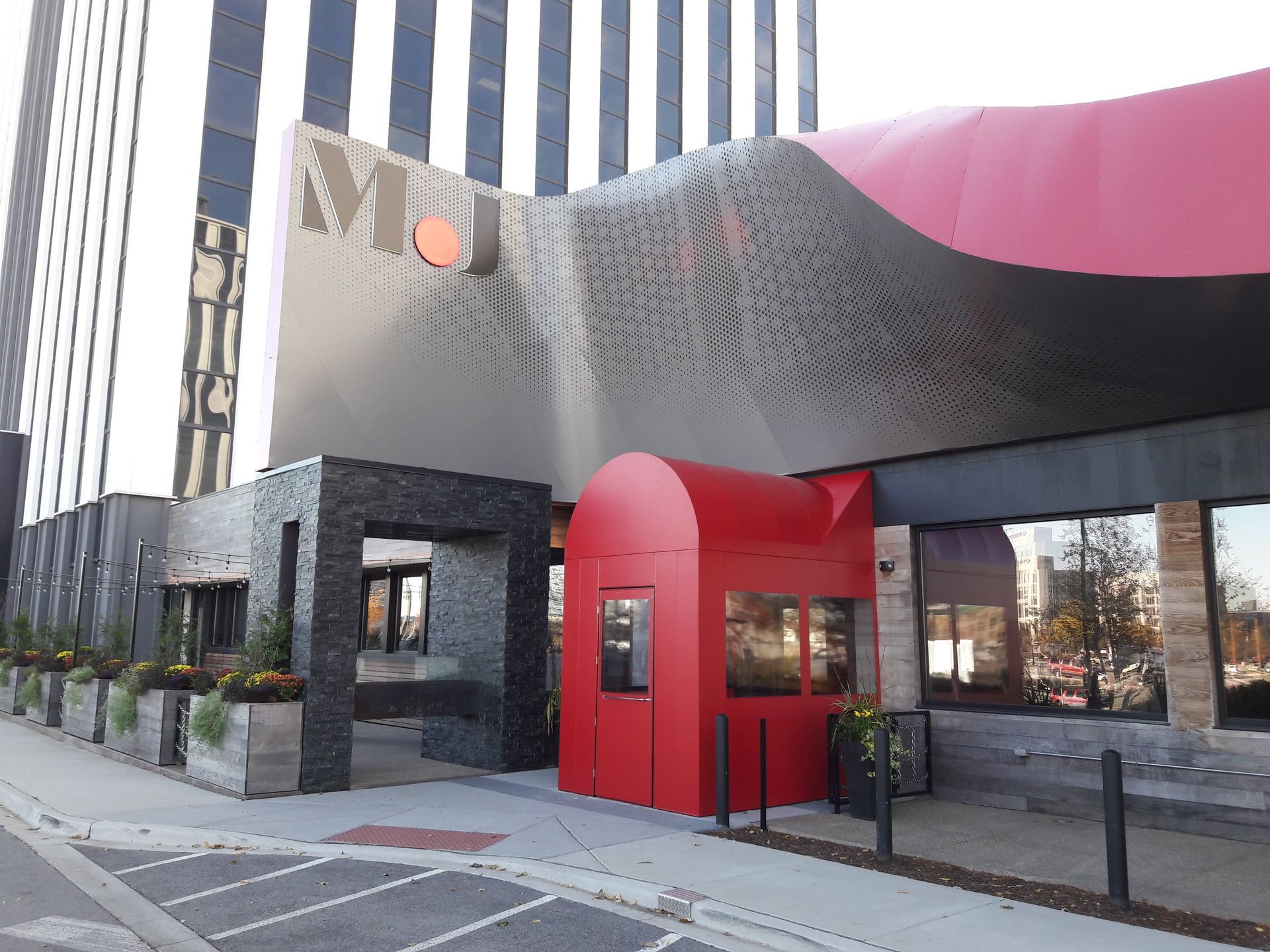 A building with a red awning on the side of it