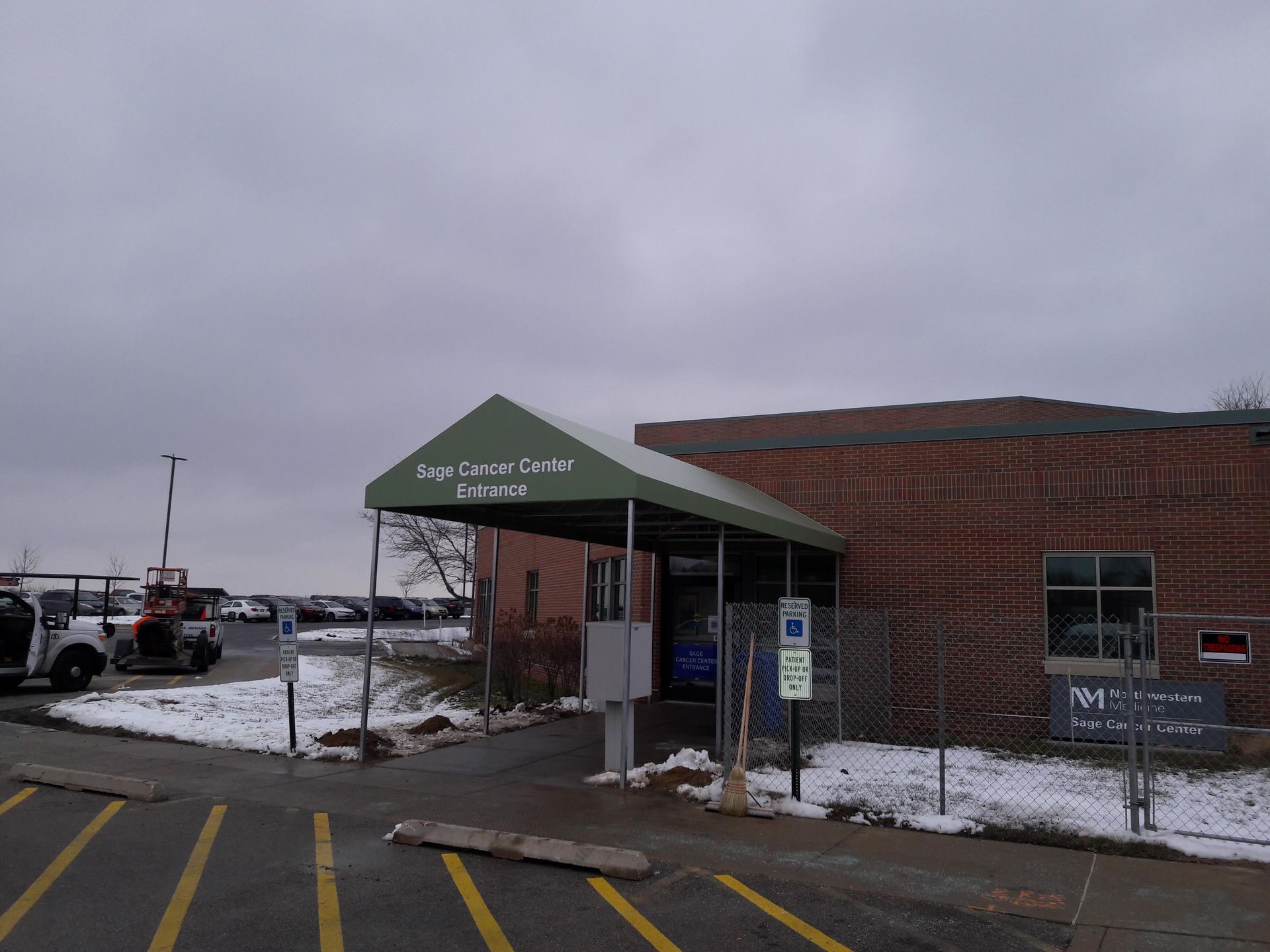 A brick building with a green awning over the entrance