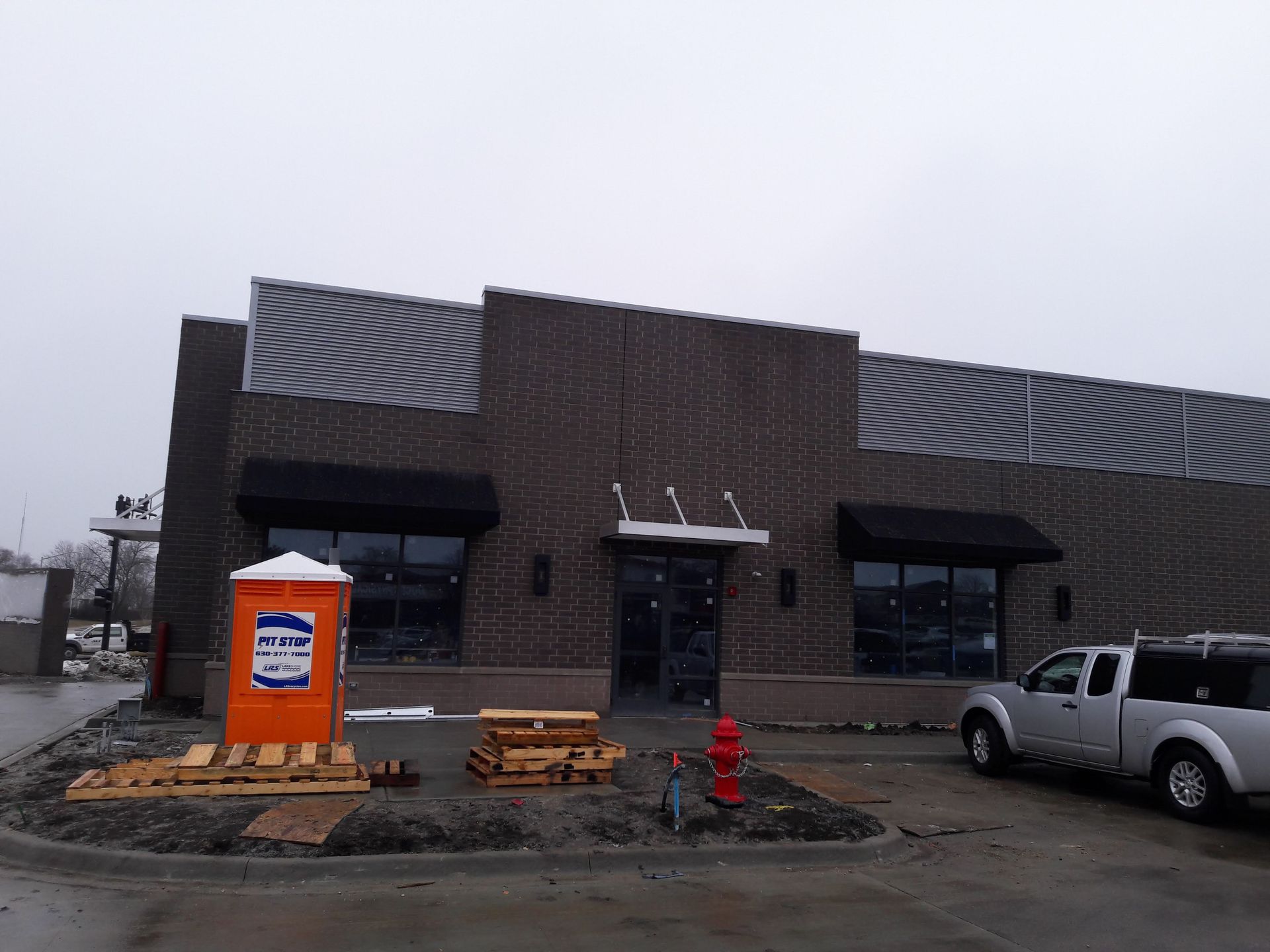 A brick building with a fire hydrant in front of it