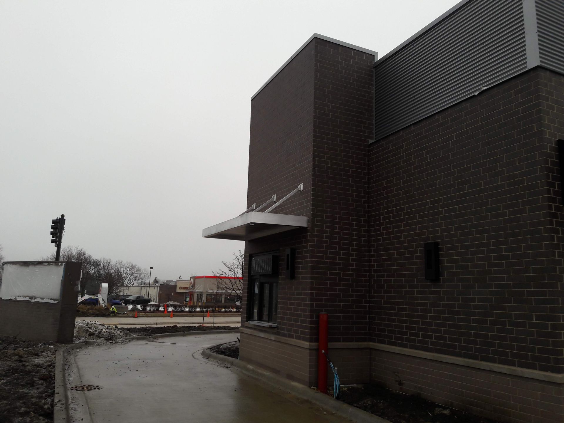 A brick building with a canopy on the side of it
