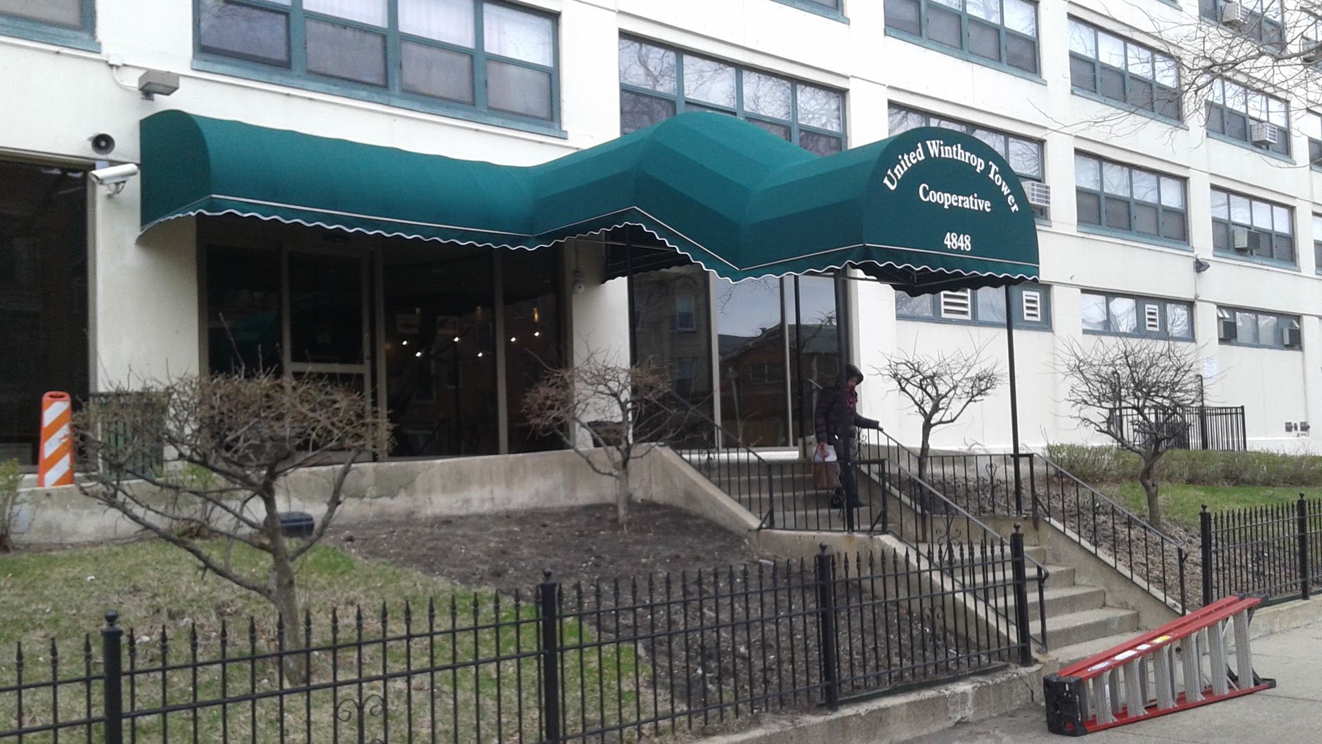 A building with a green awning over the entrance