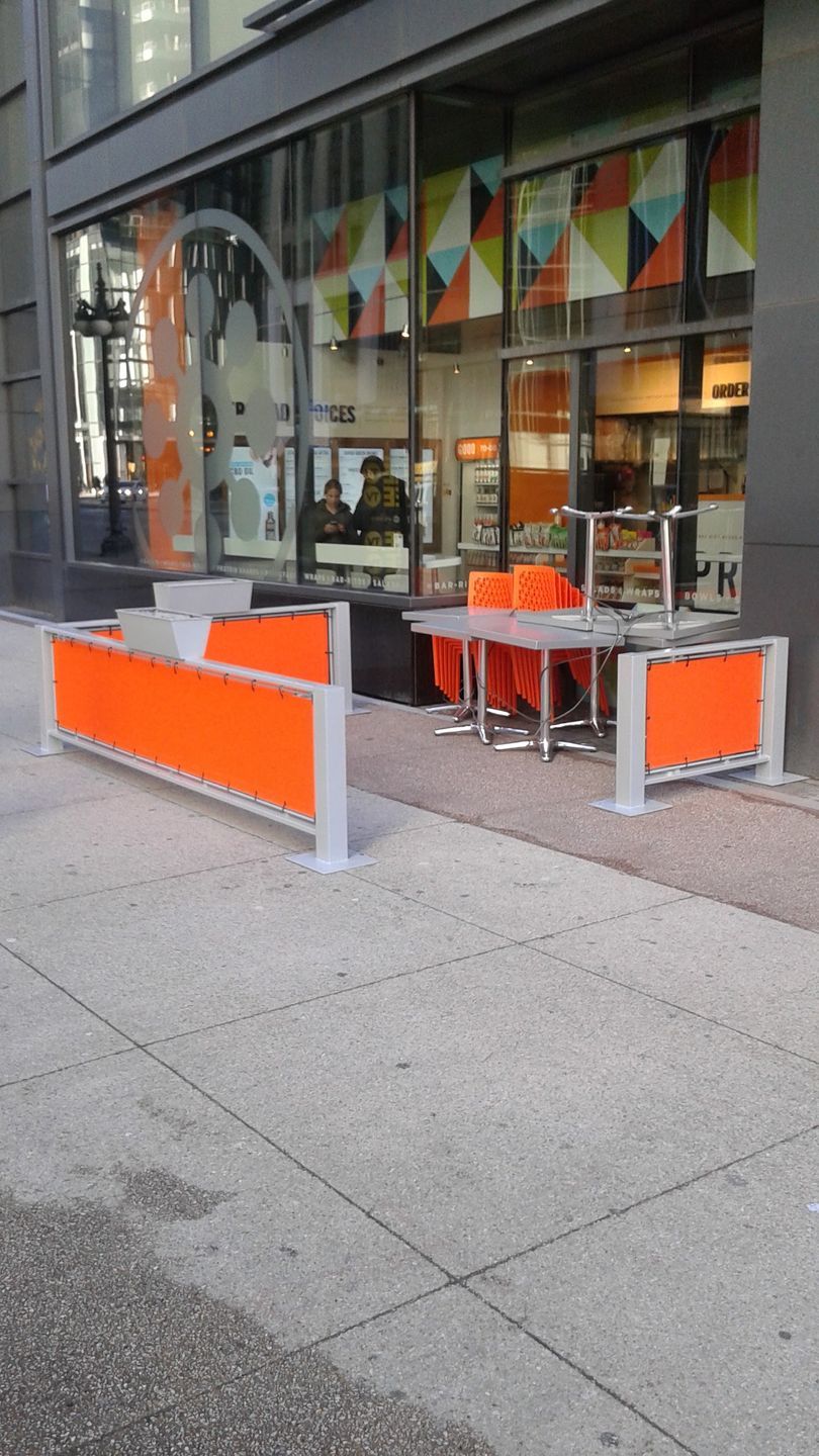 A building with tables and chairs outside of it