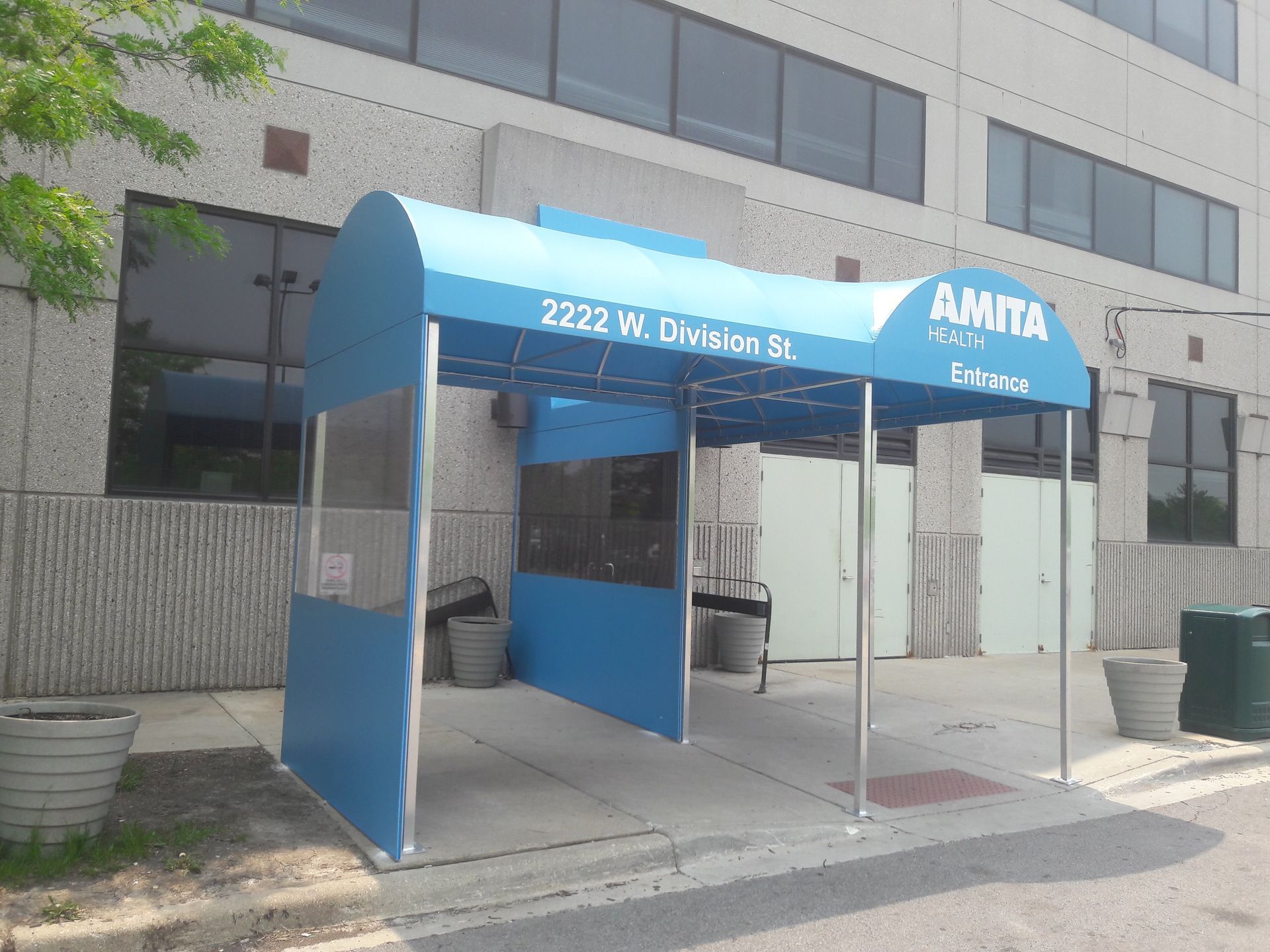 A blue awning with the word amita on it