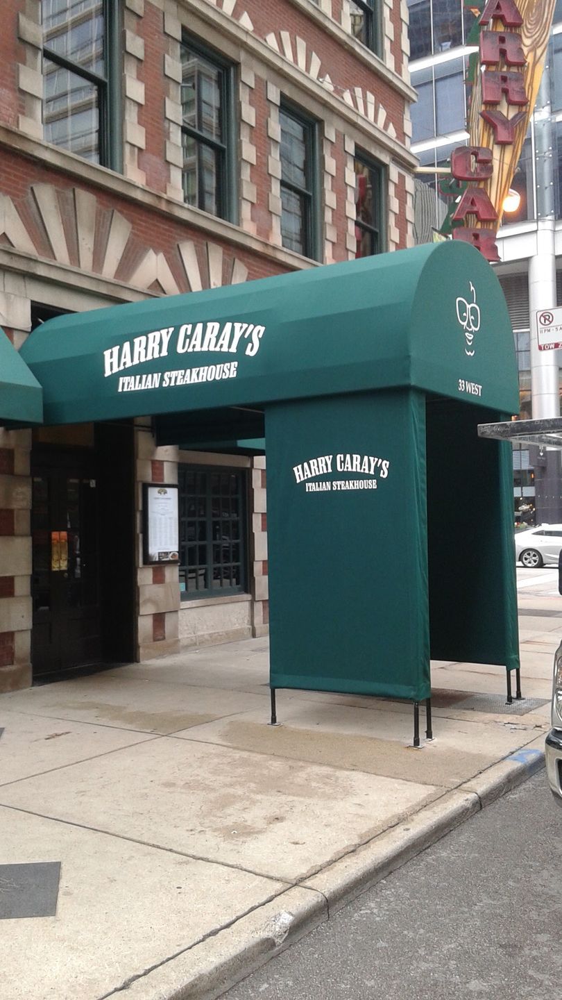 A green awning over the entrance to harry carapy 's