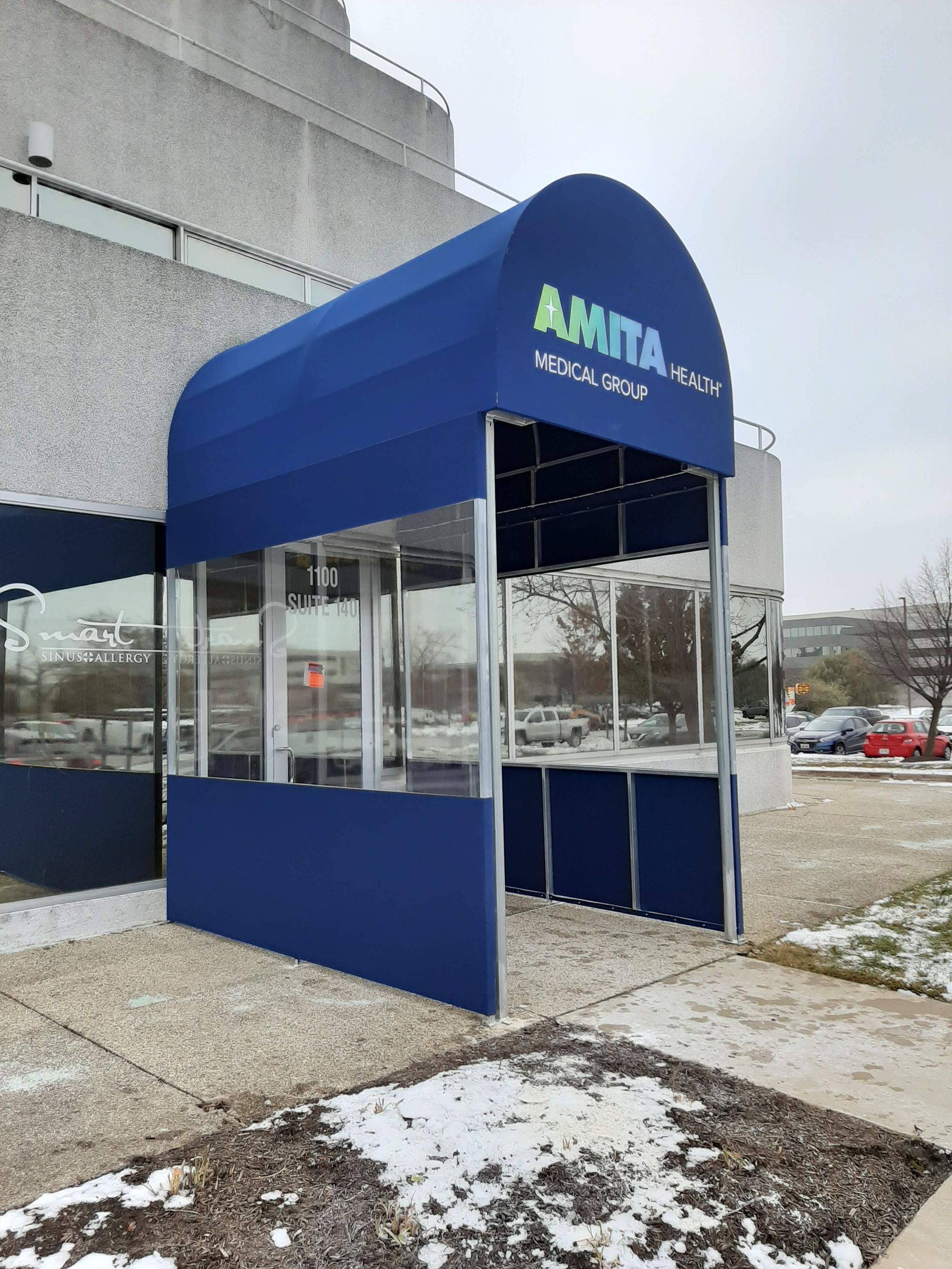 A blue awning with the word amita on it