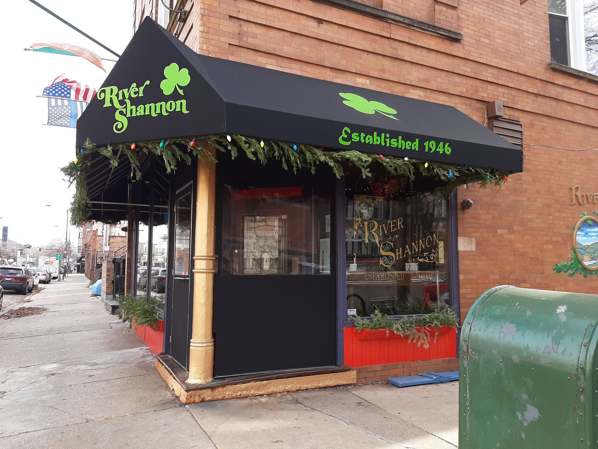 A store front with a black awning that says river shamrock