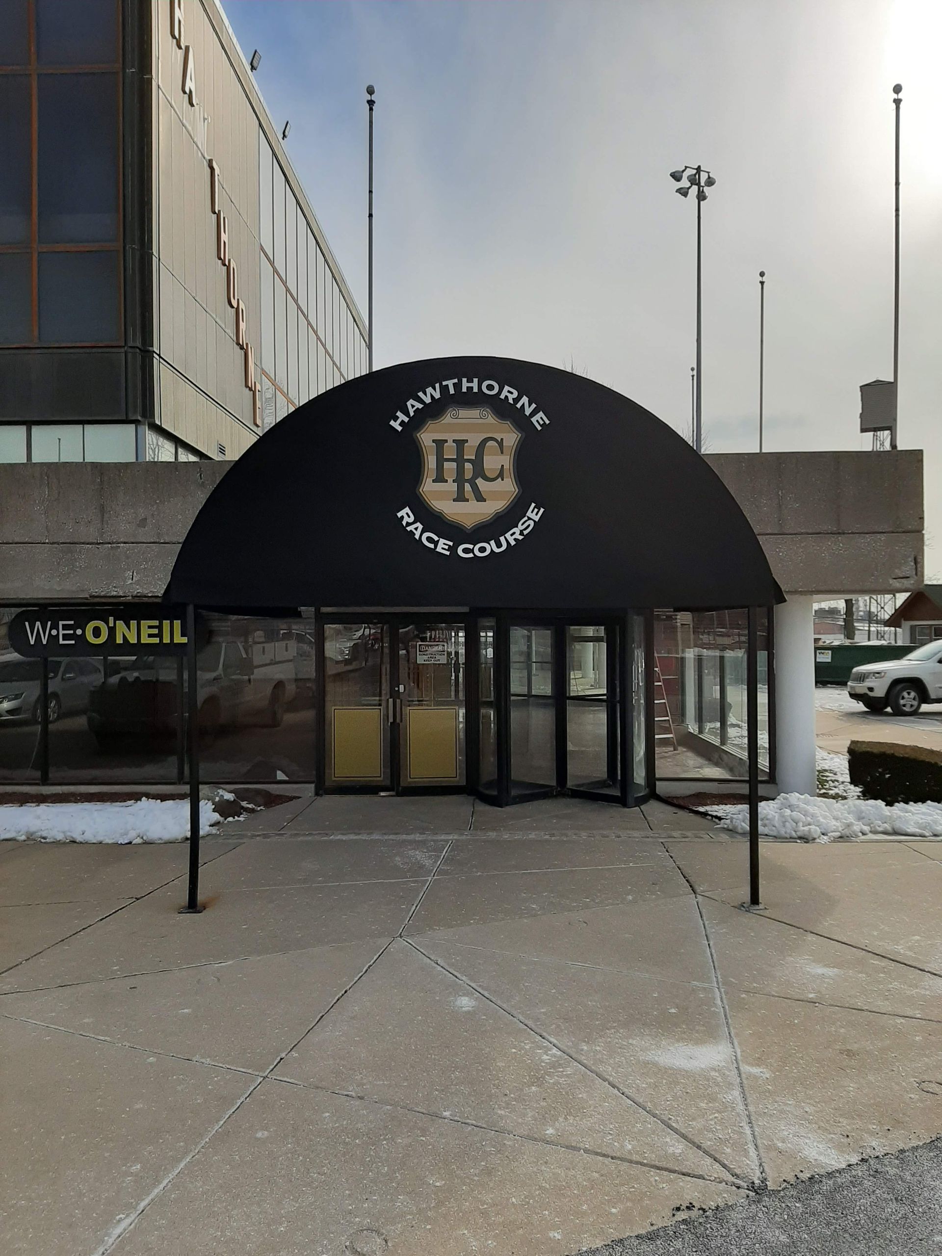 A building with a black awning that says hc on it