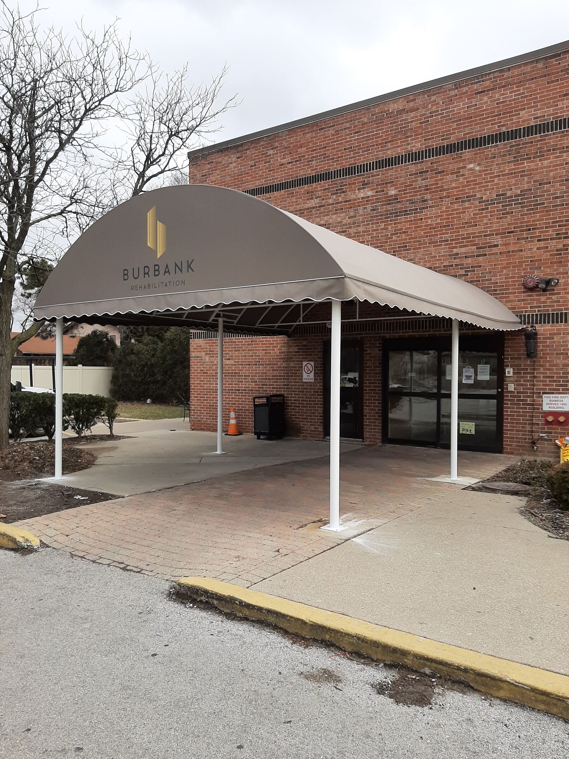 A large brick building with a canopy over the entrance.