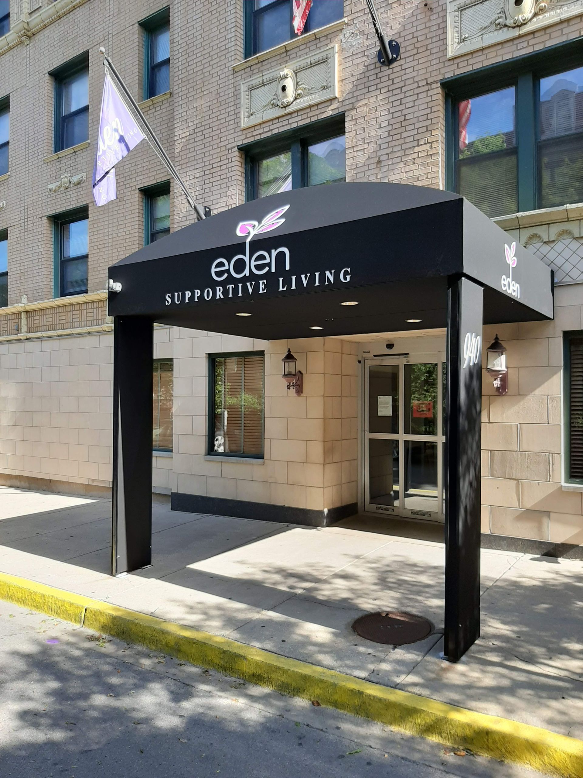 A building with a canopy over the entrance that says eden