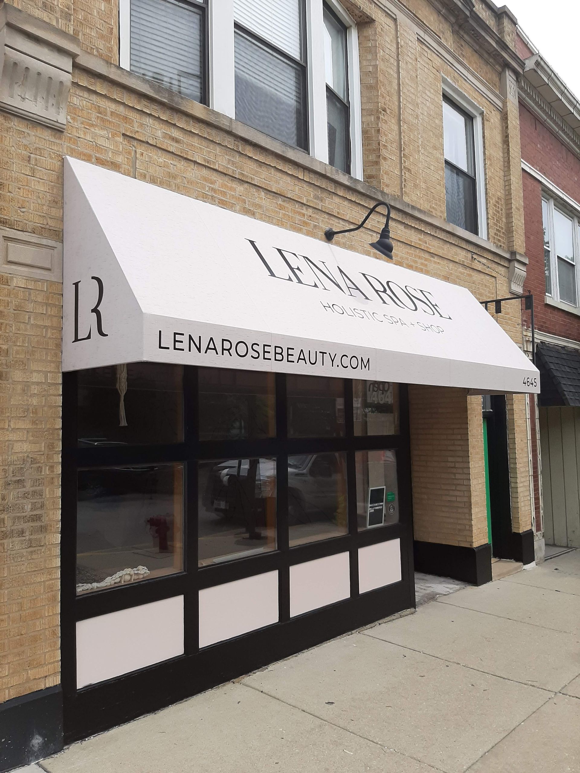 A brick building with a white awning over the entrance