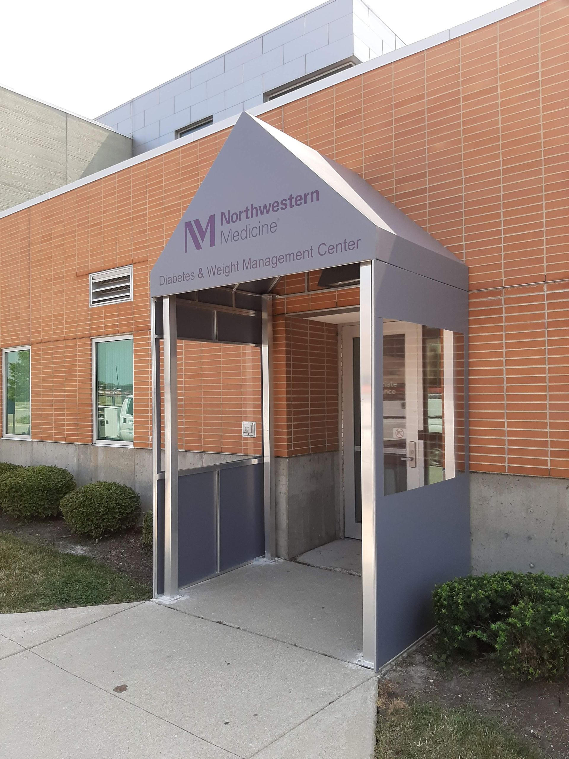 A brick building with a canopy over the entrance