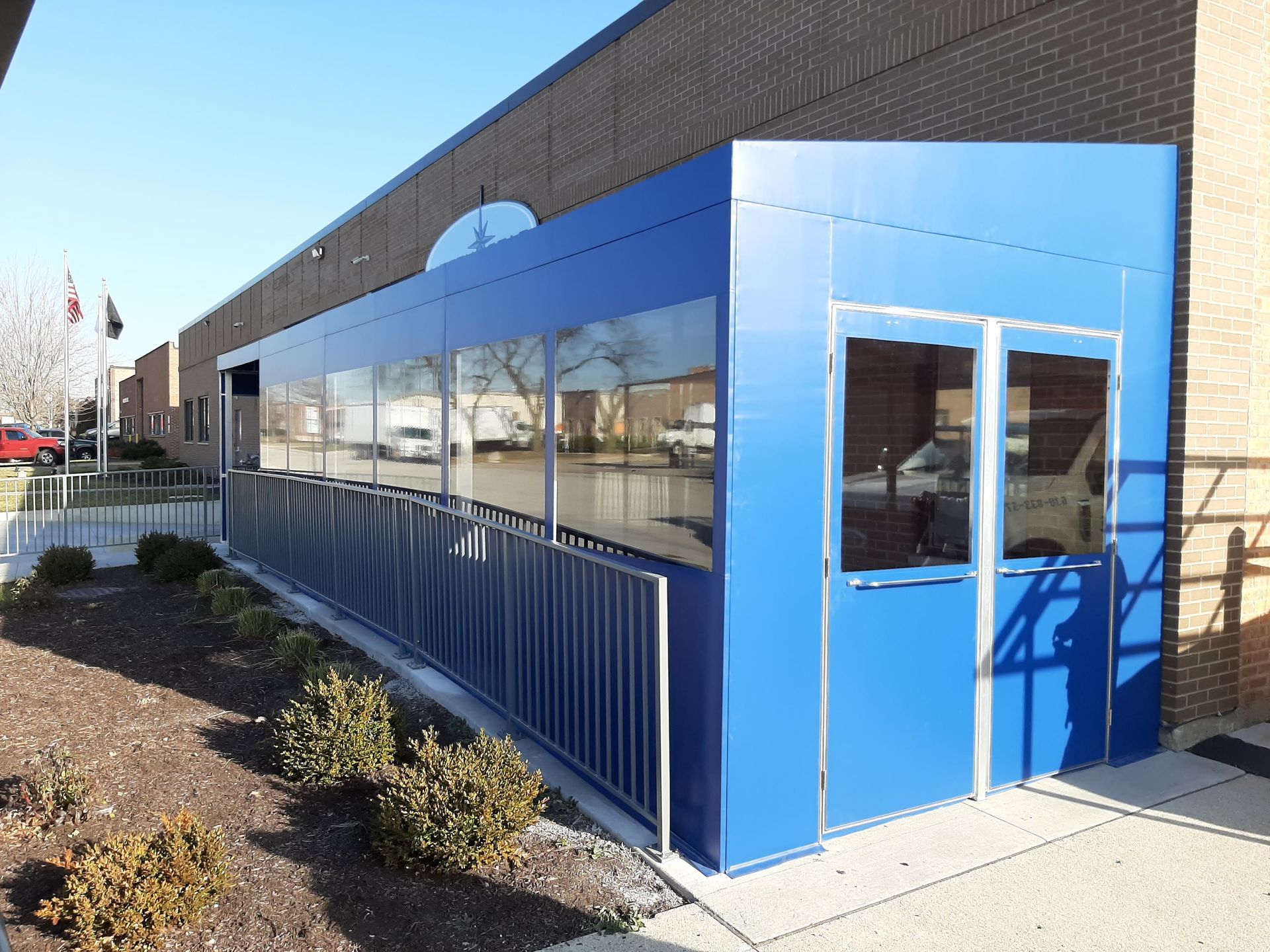 A blue building with a walkway leading to it