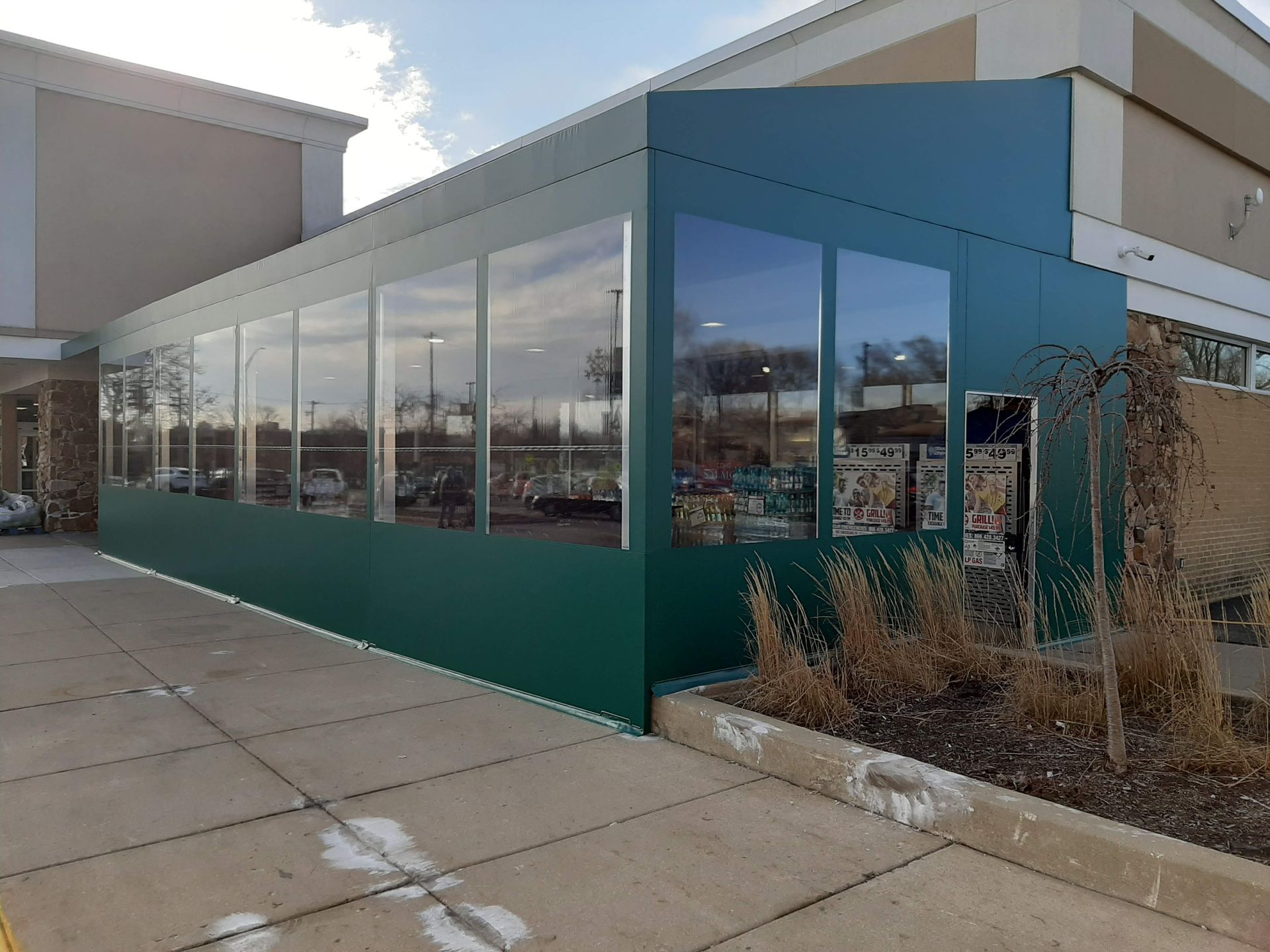 A building with a lot of windows and a green wall