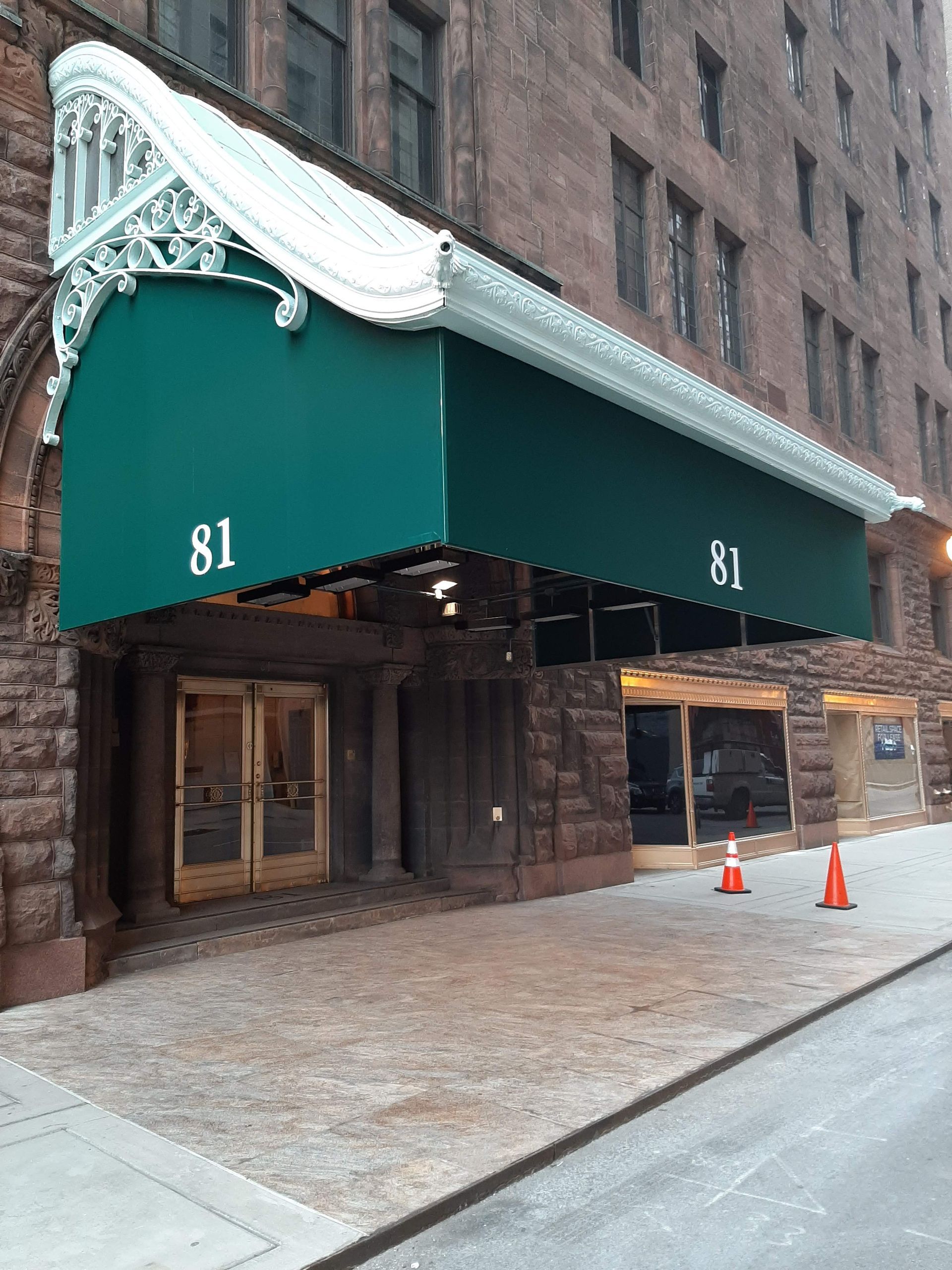 A large building with a green awning over the entrance.