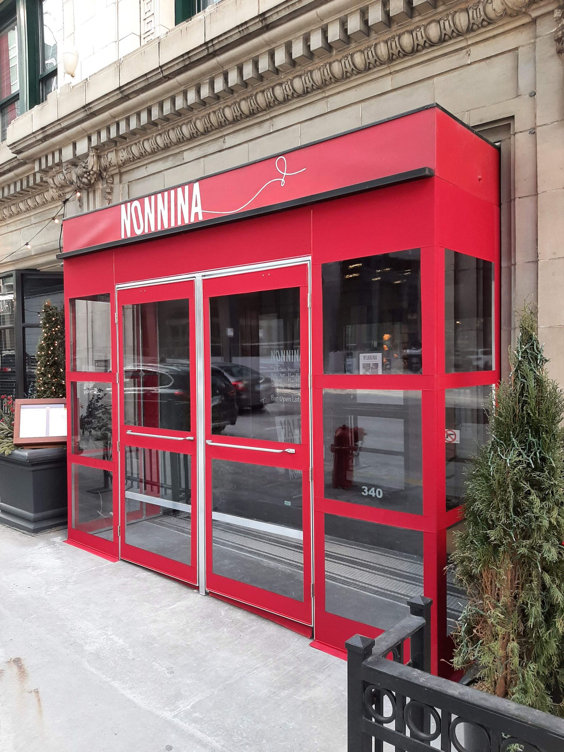 A red building with a sign that says nomina on it