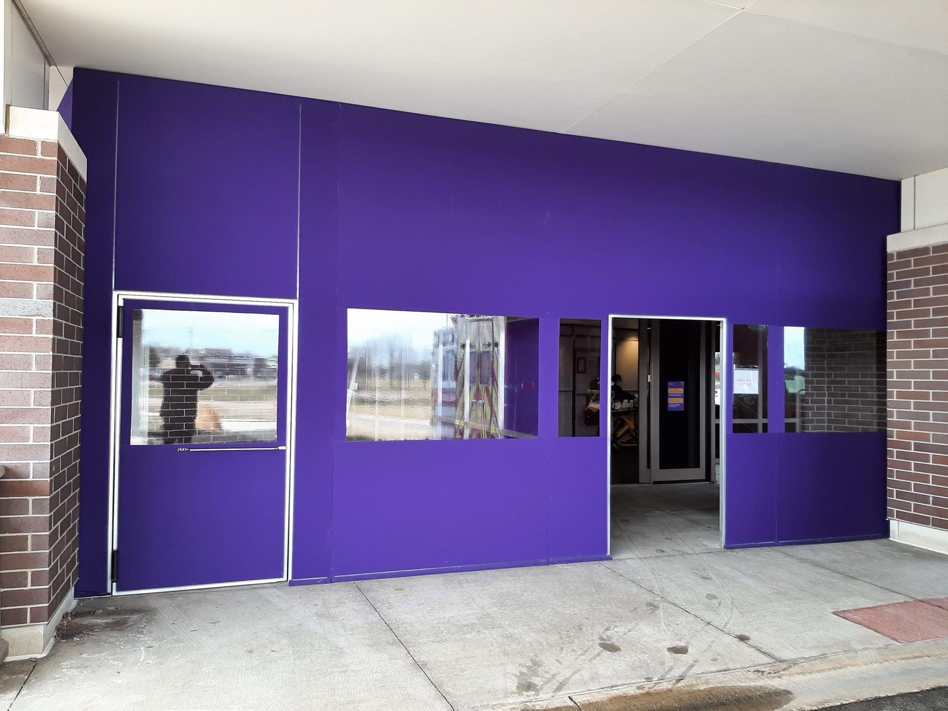 A purple building with a lot of windows and doors