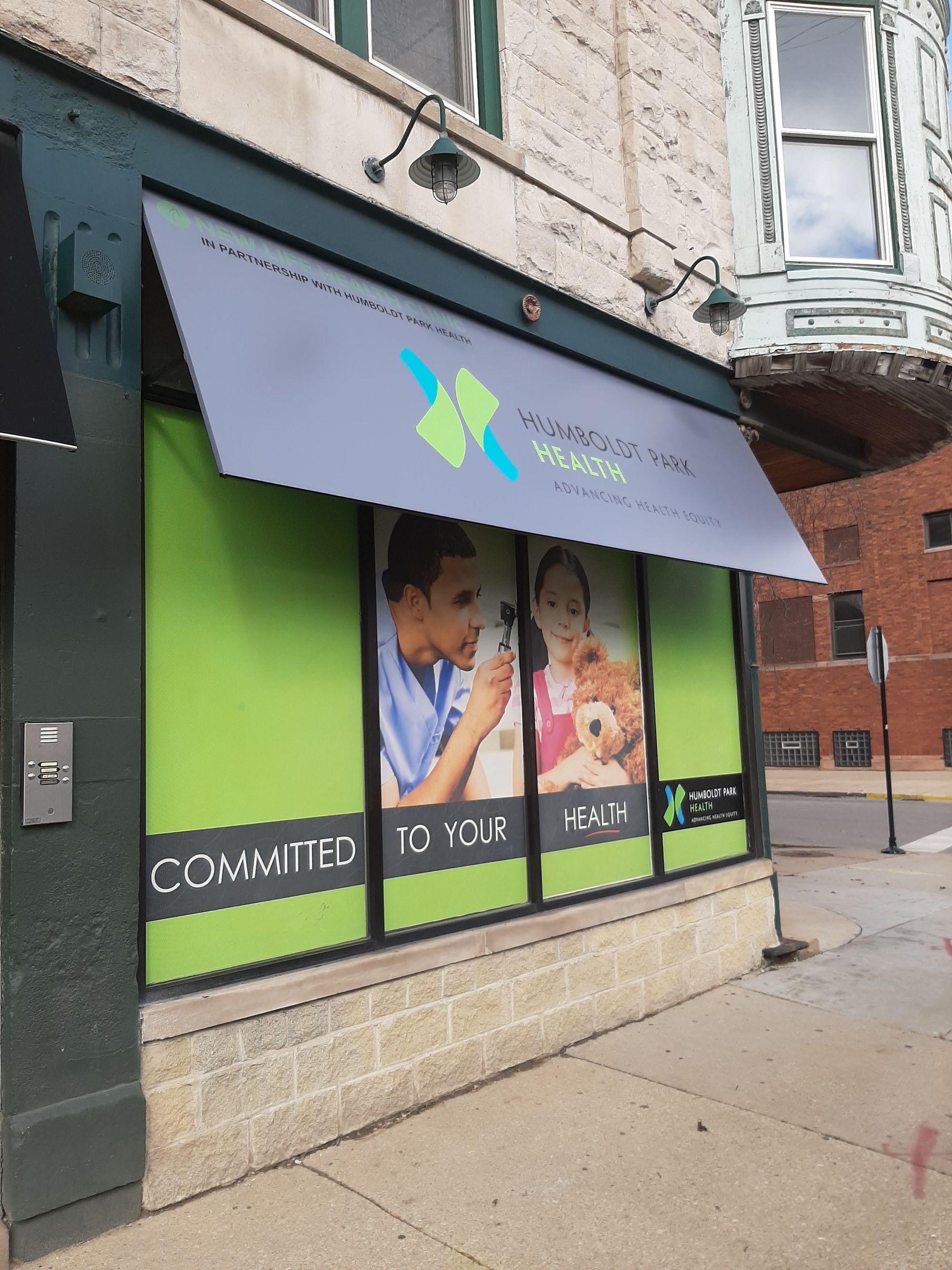 A store front with a sign that says committed to your health