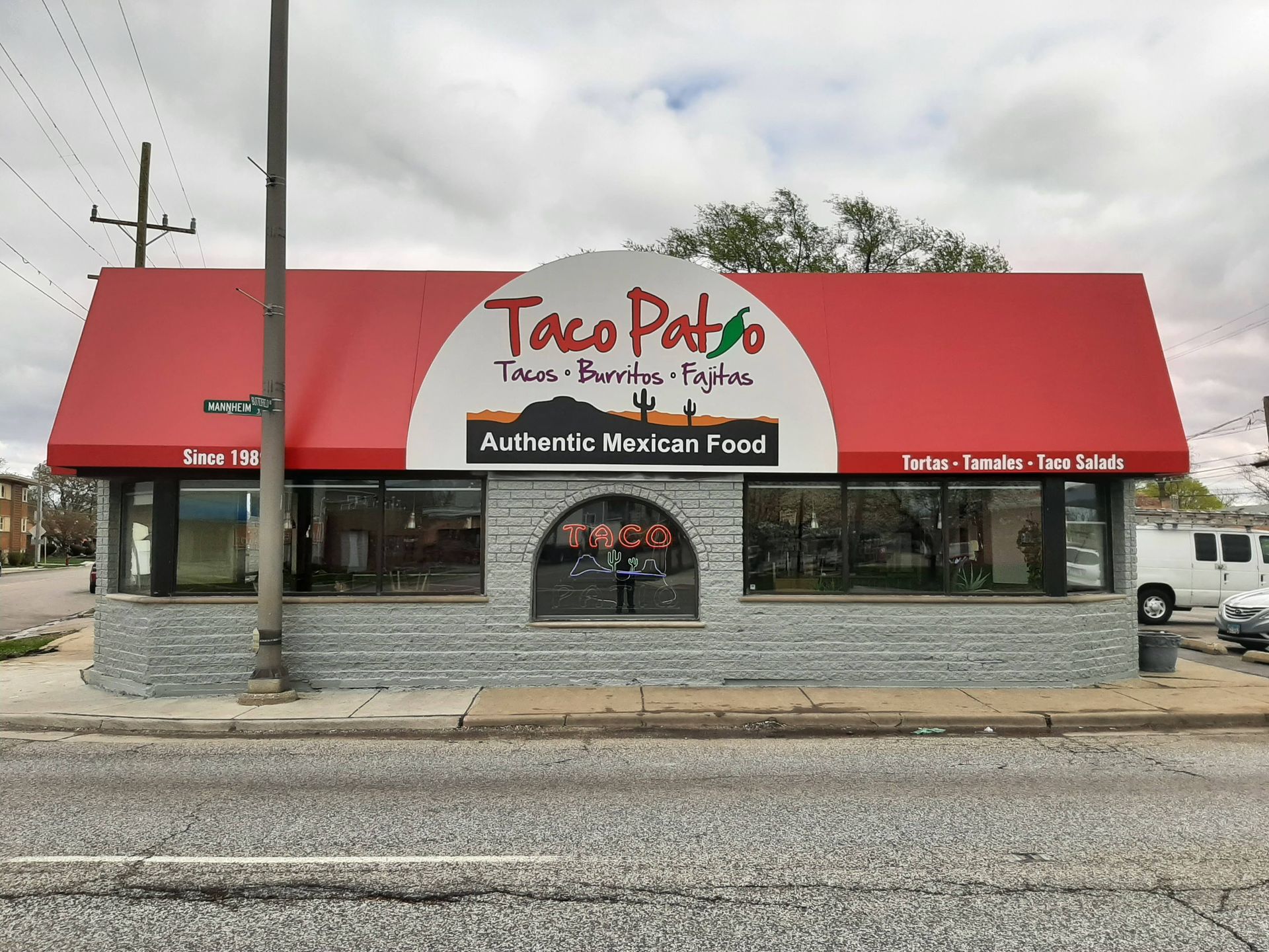 A taco patio restaurant with a red awning