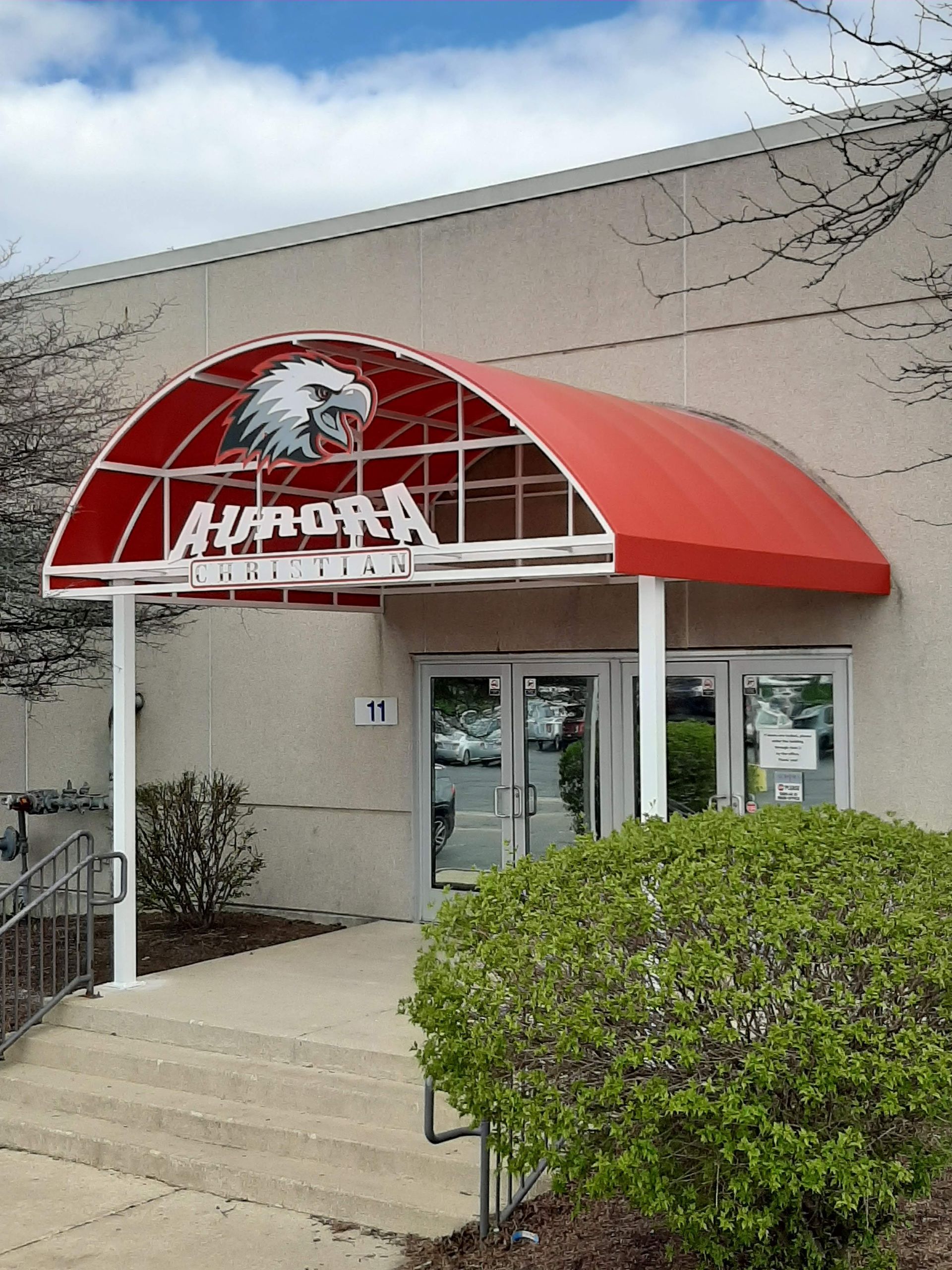 A building with a red awning that says aurora on it
