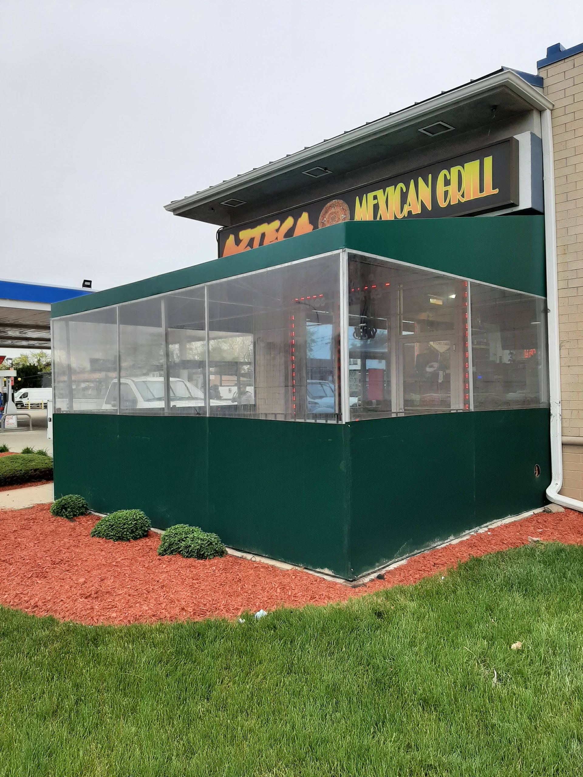 A restaurant with a green awning on the side of it.