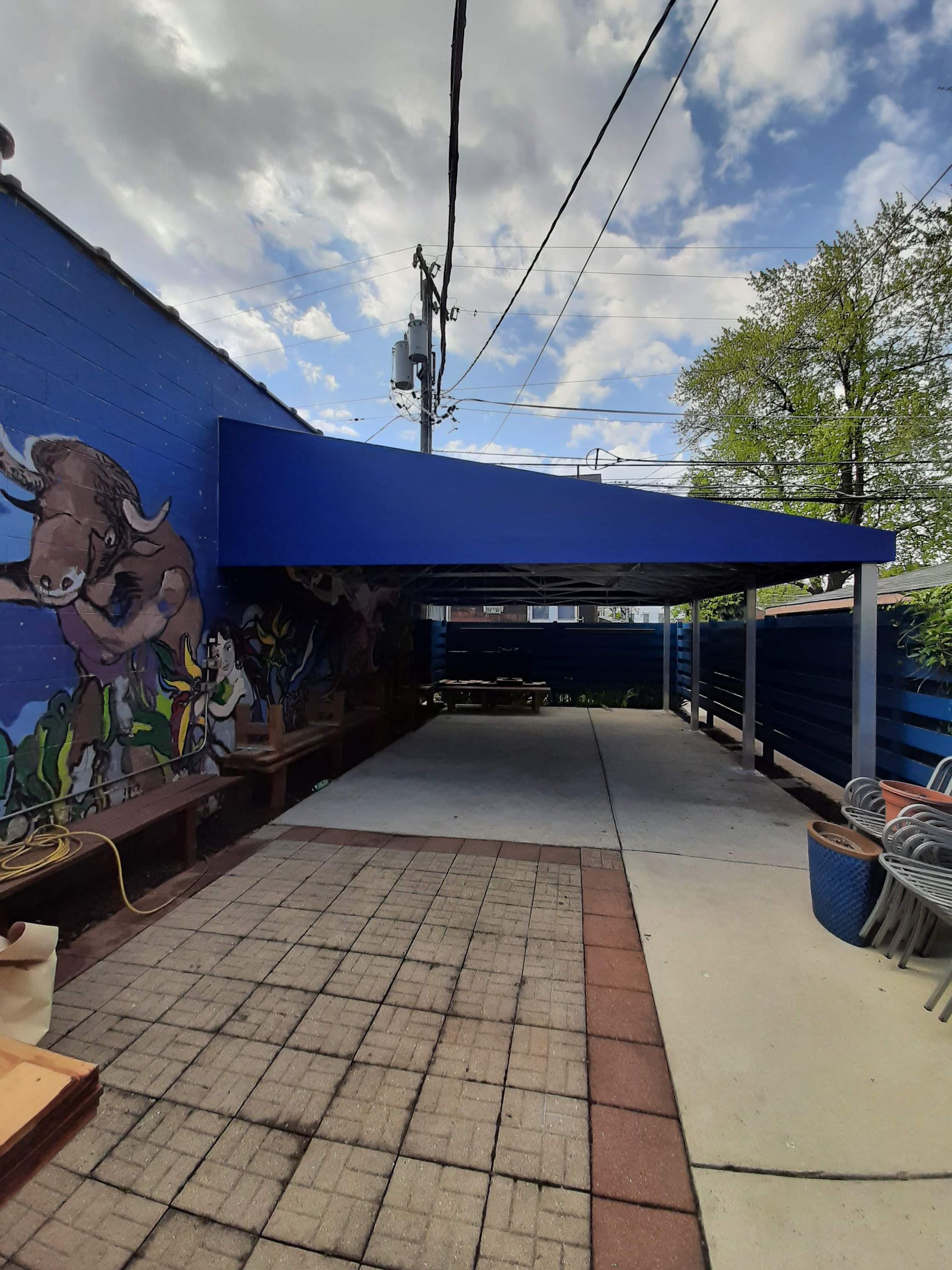A blue awning with a painting of a bull on it