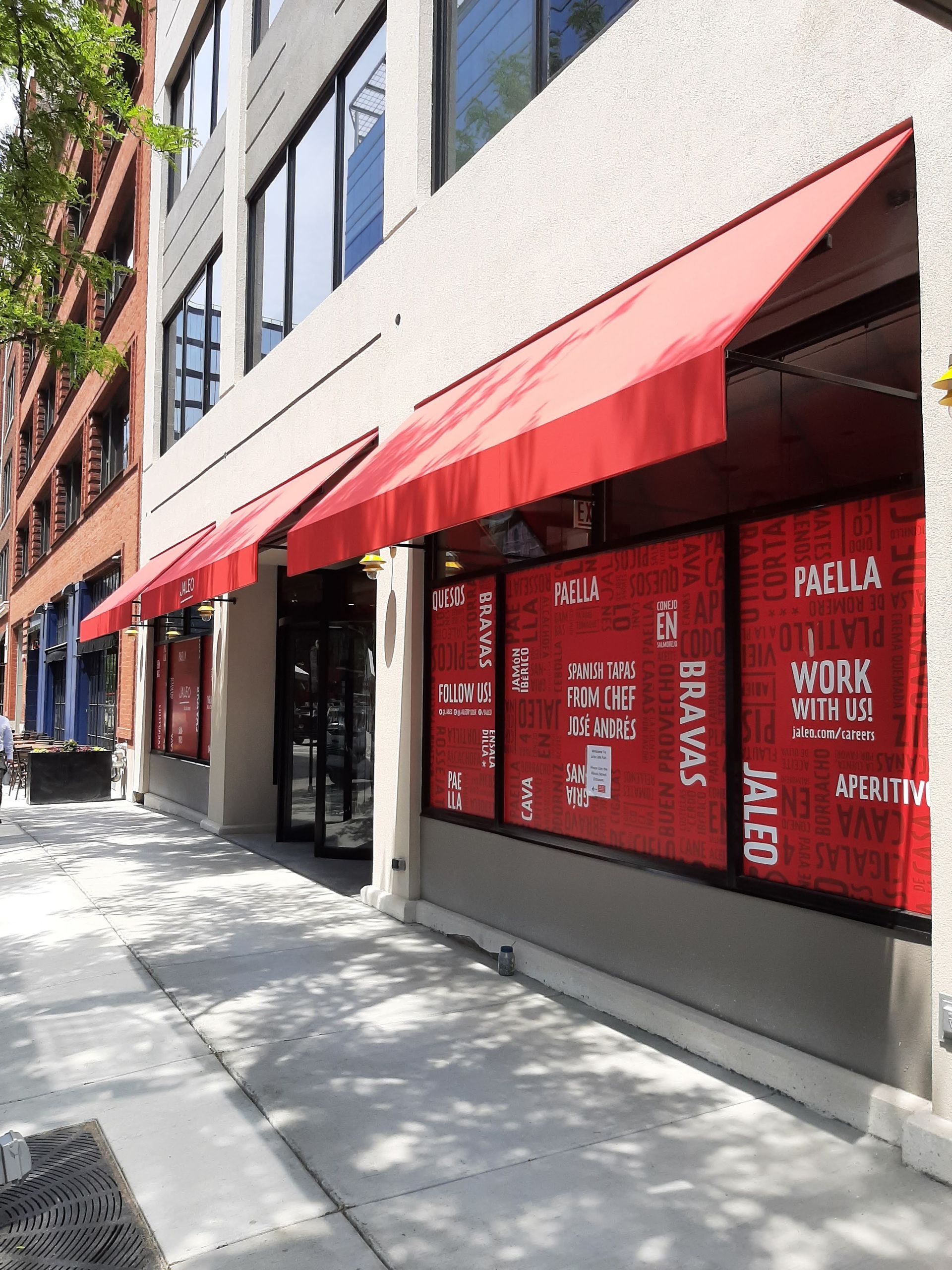 A building with a red awning on the side of it
