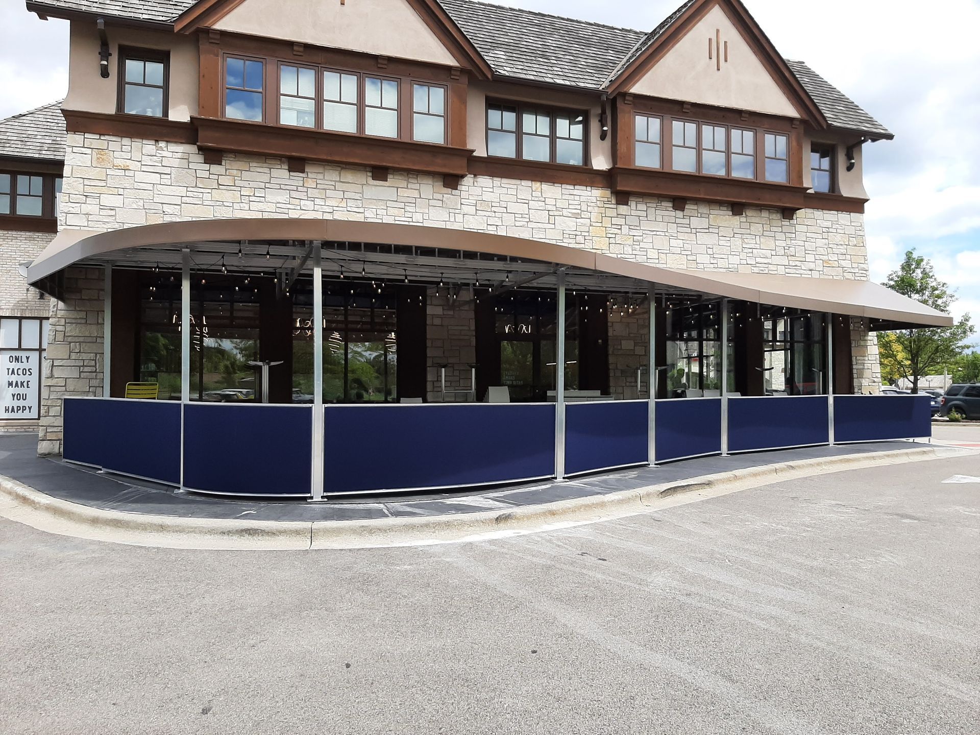 A large building with a lot of windows and a blue awning