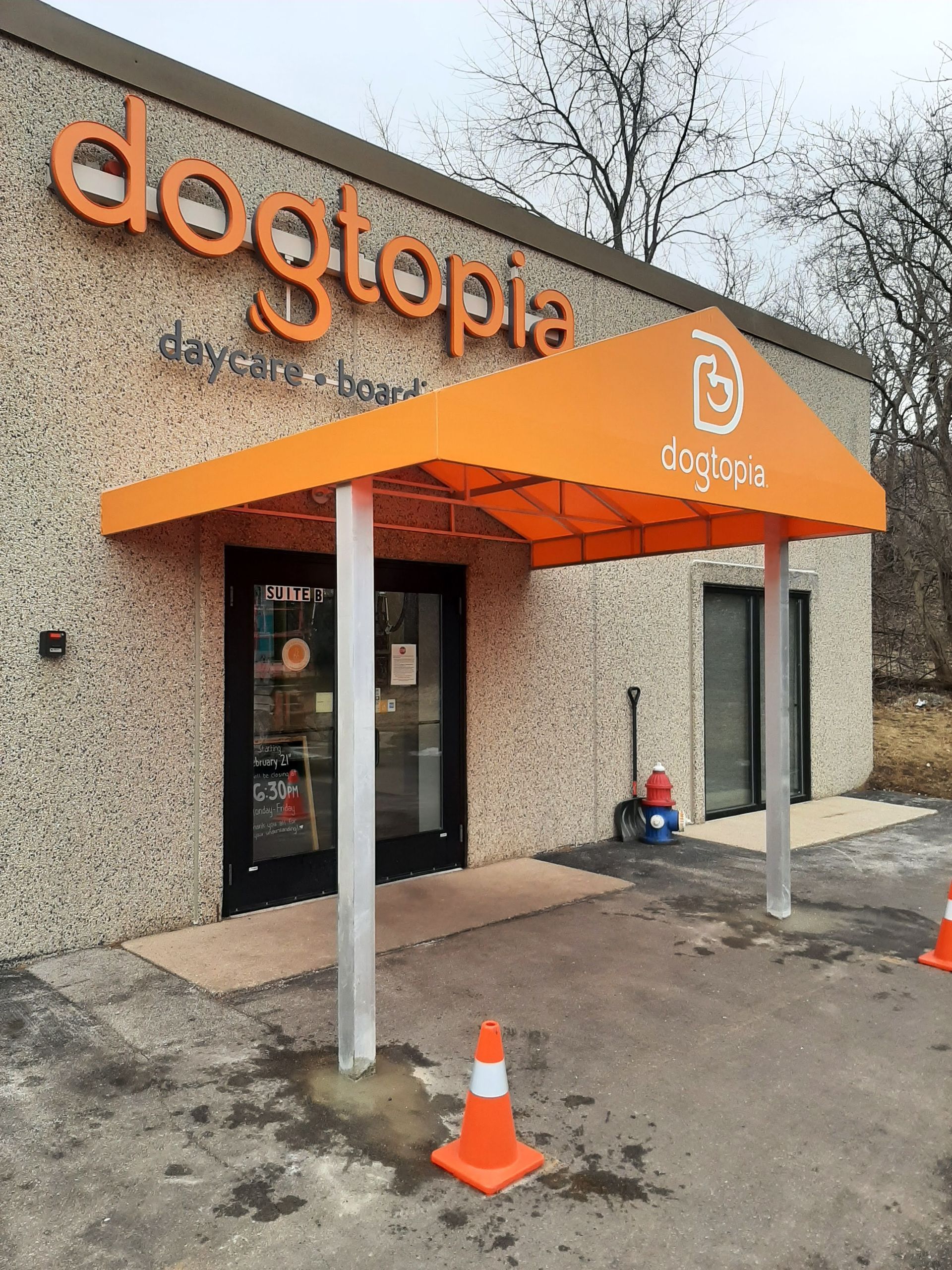 A dogtopia store with an orange awning over the entrance.