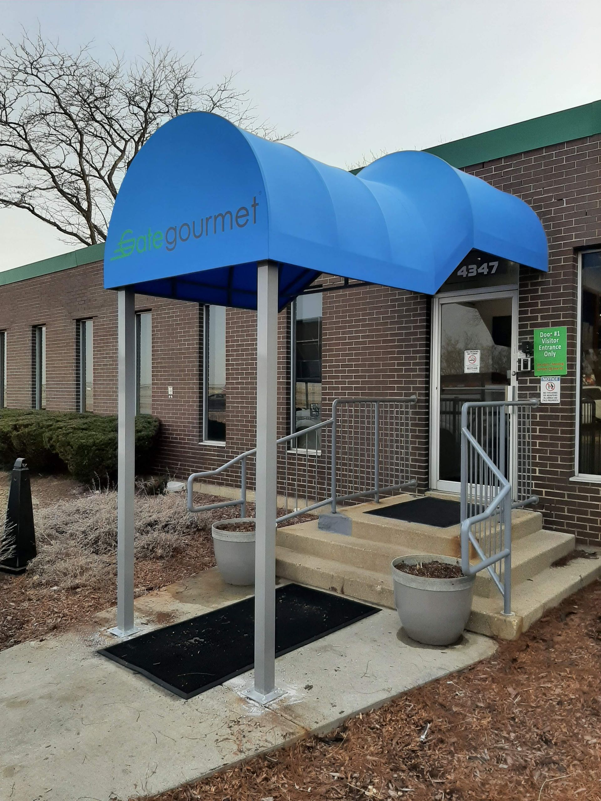 A blue awning with the word gourmet on it