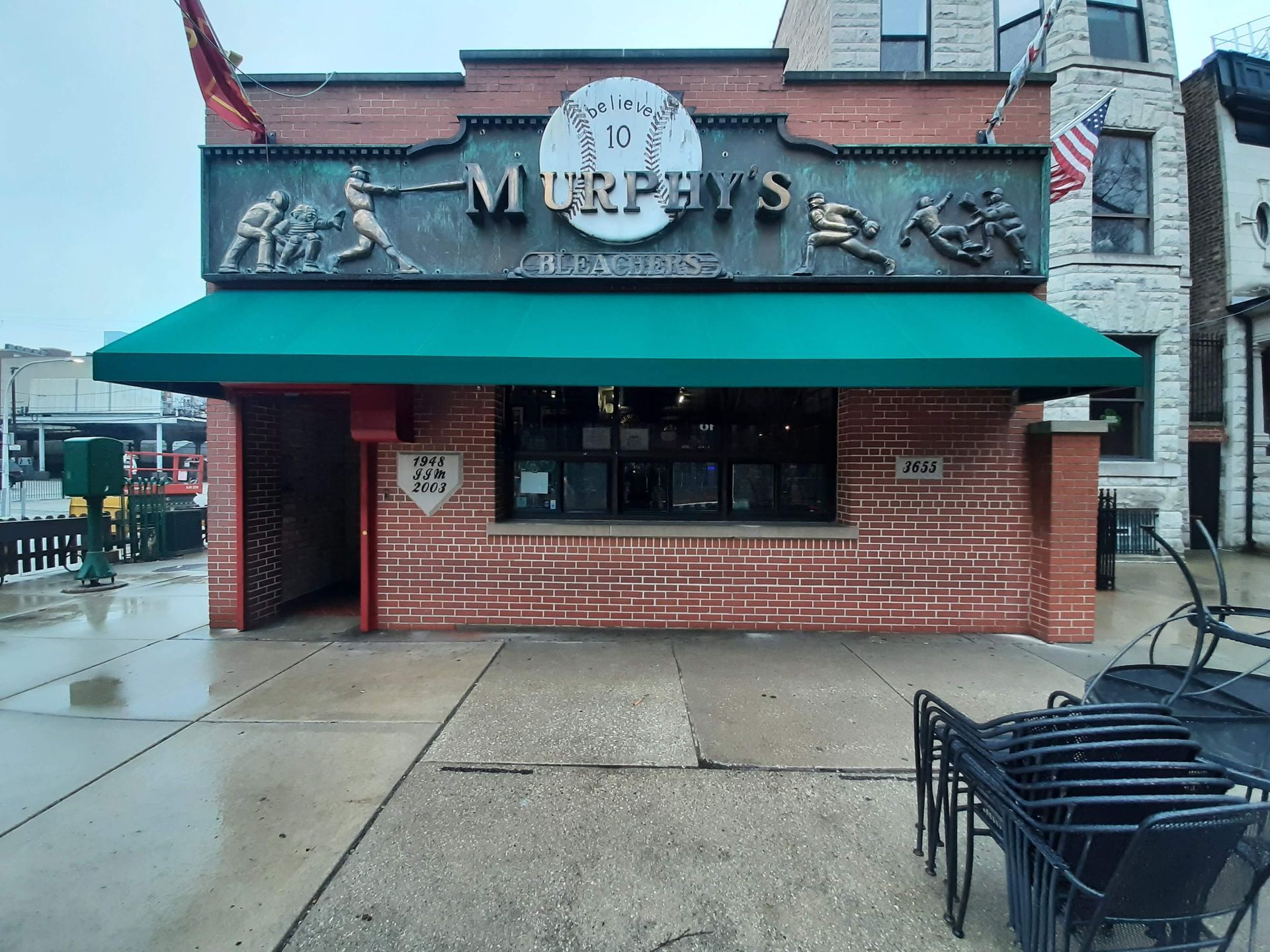 A brick building with a green awning and a sign that says murphy 's