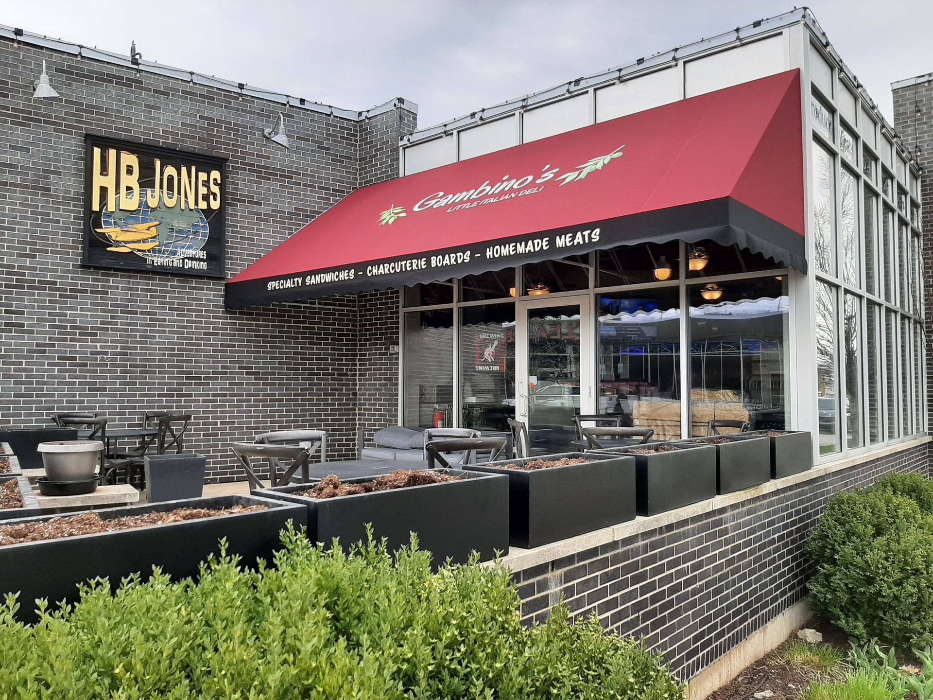 A restaurant with a red awning and a sign that says hb jones