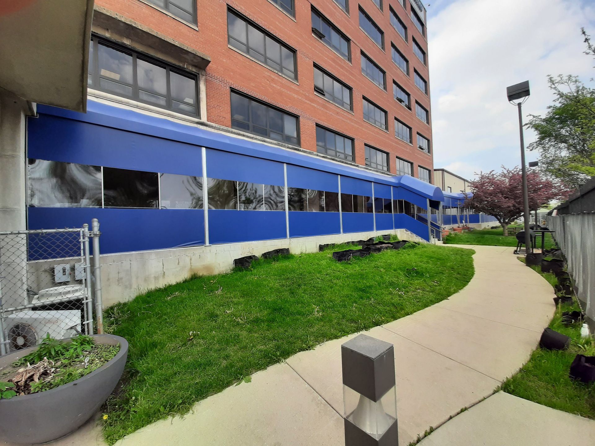A brick building with a blue awning on the side of it