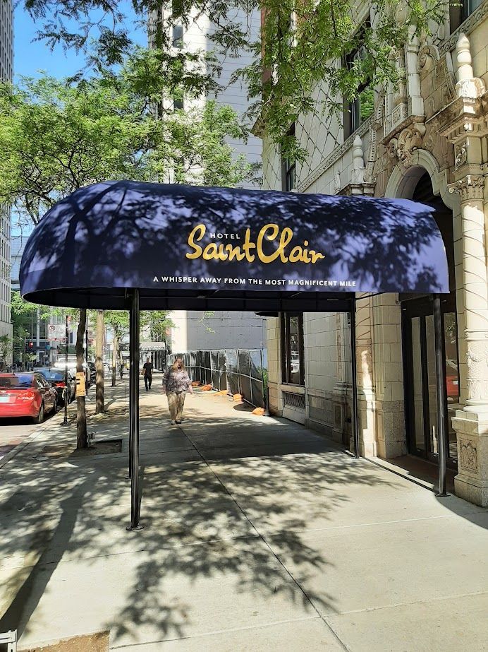 A blue awning is covering the entrance to a building.