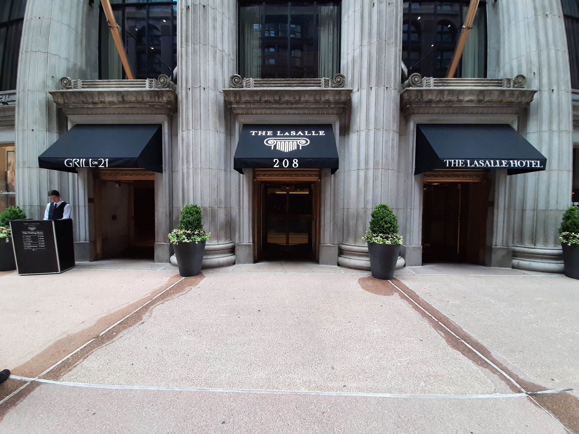 A large building with a black awning that says the lombard hotel