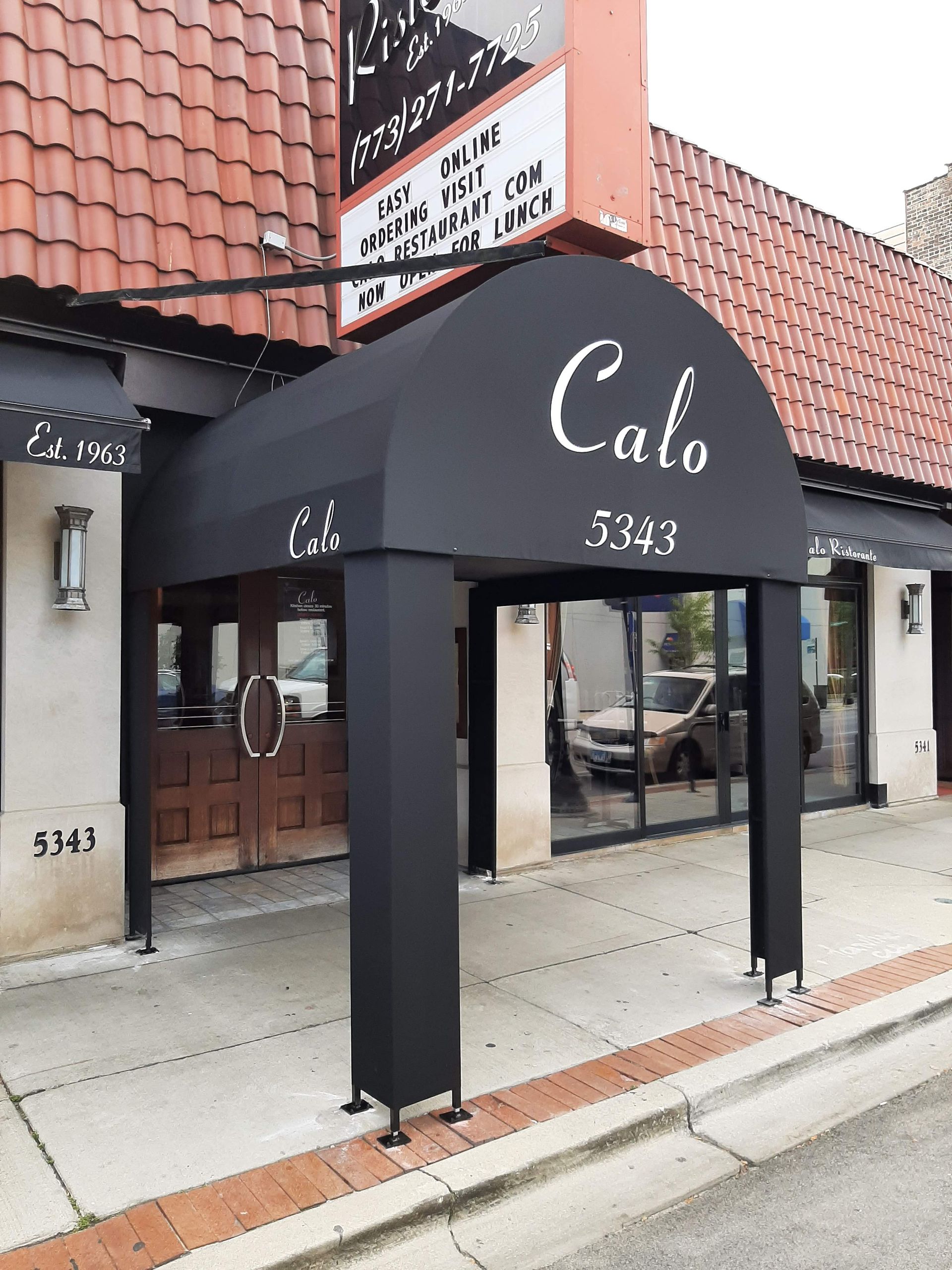 A black awning with the word calo on it