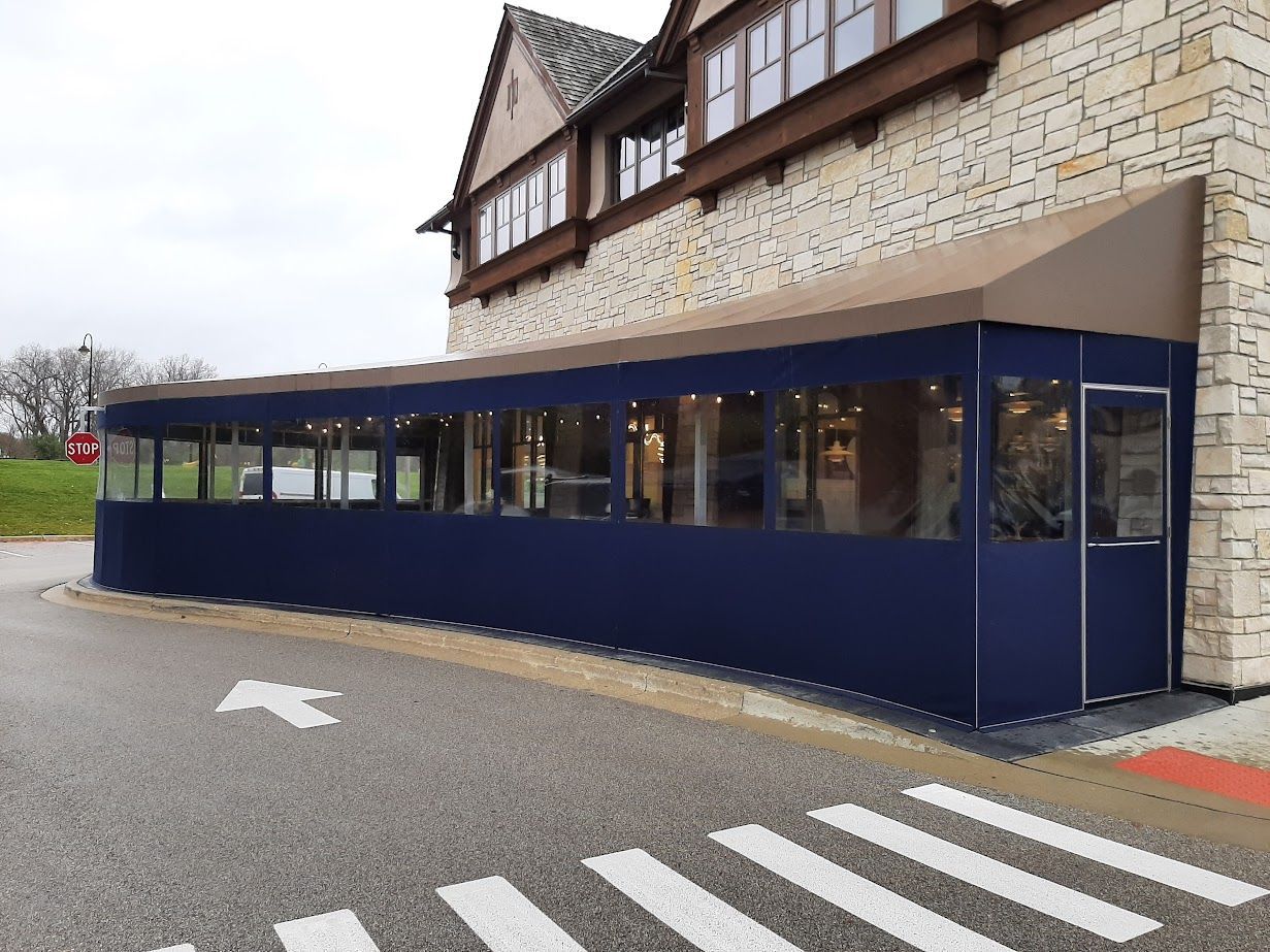 A large building with a blue awning on the side of it.