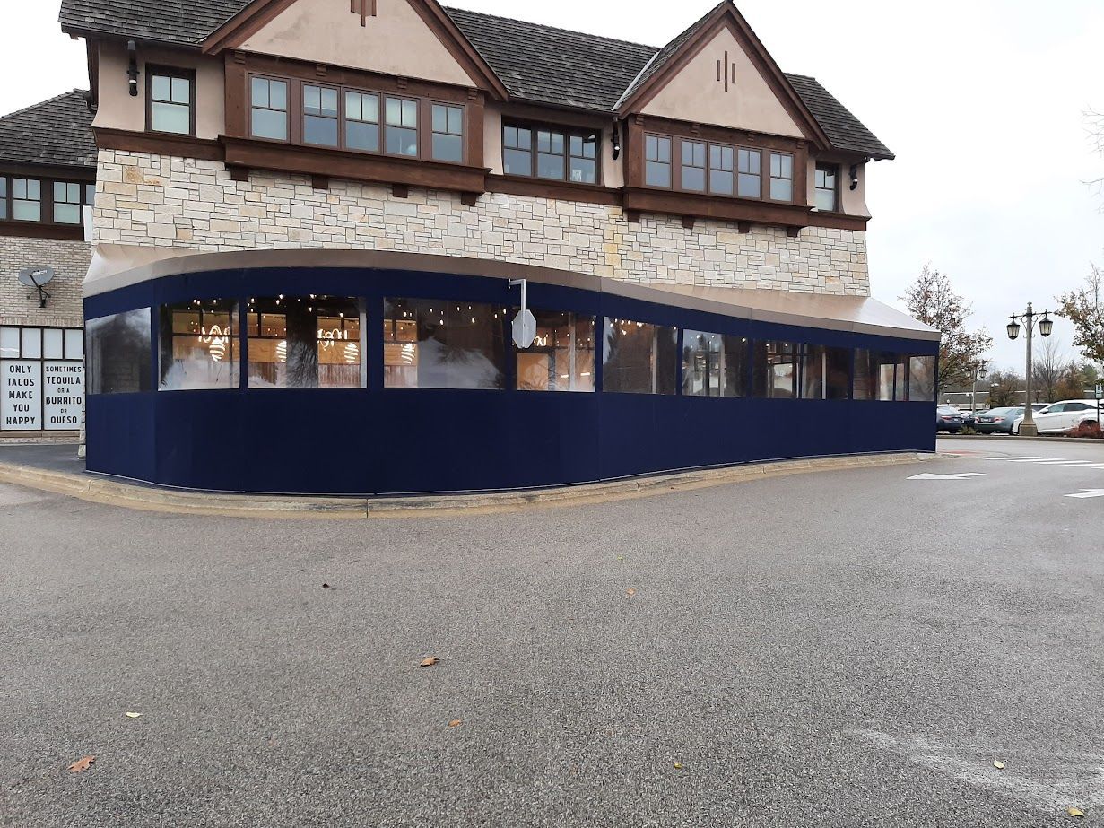 A large building with a blue awning on the side of it