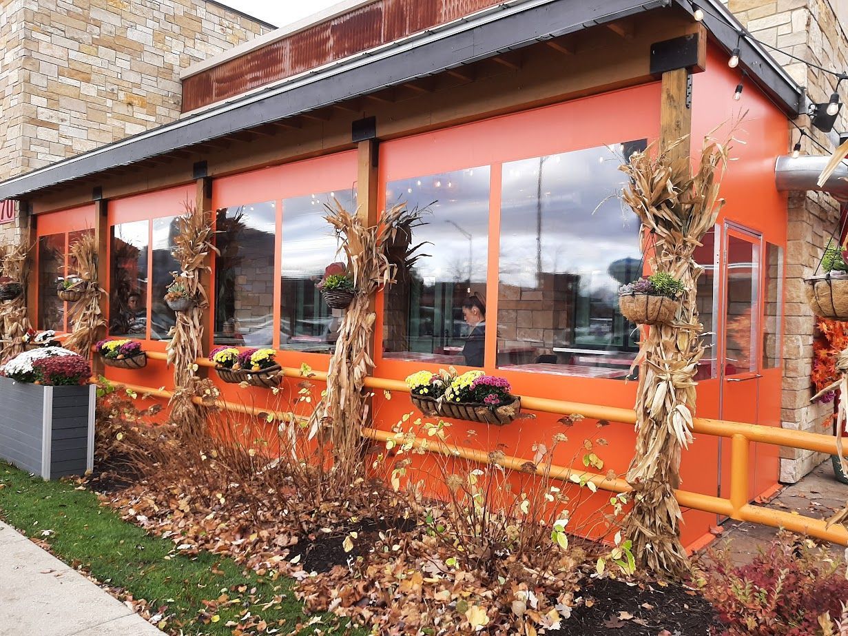 A building with a lot of windows and flowers in front of it.