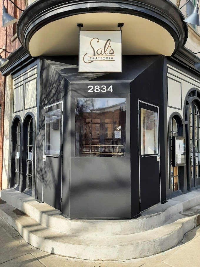 A black building with a sign that says sal 's on it