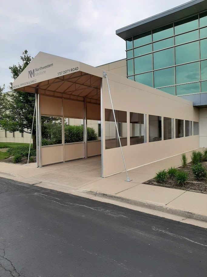A large building with a canopy on the side of it.