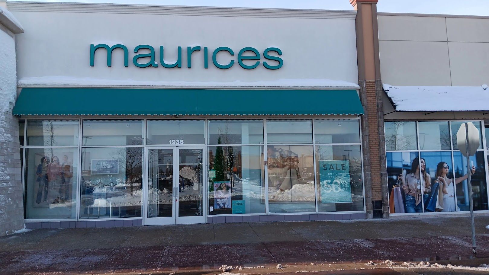 The front of a maurice 's store with a green awning