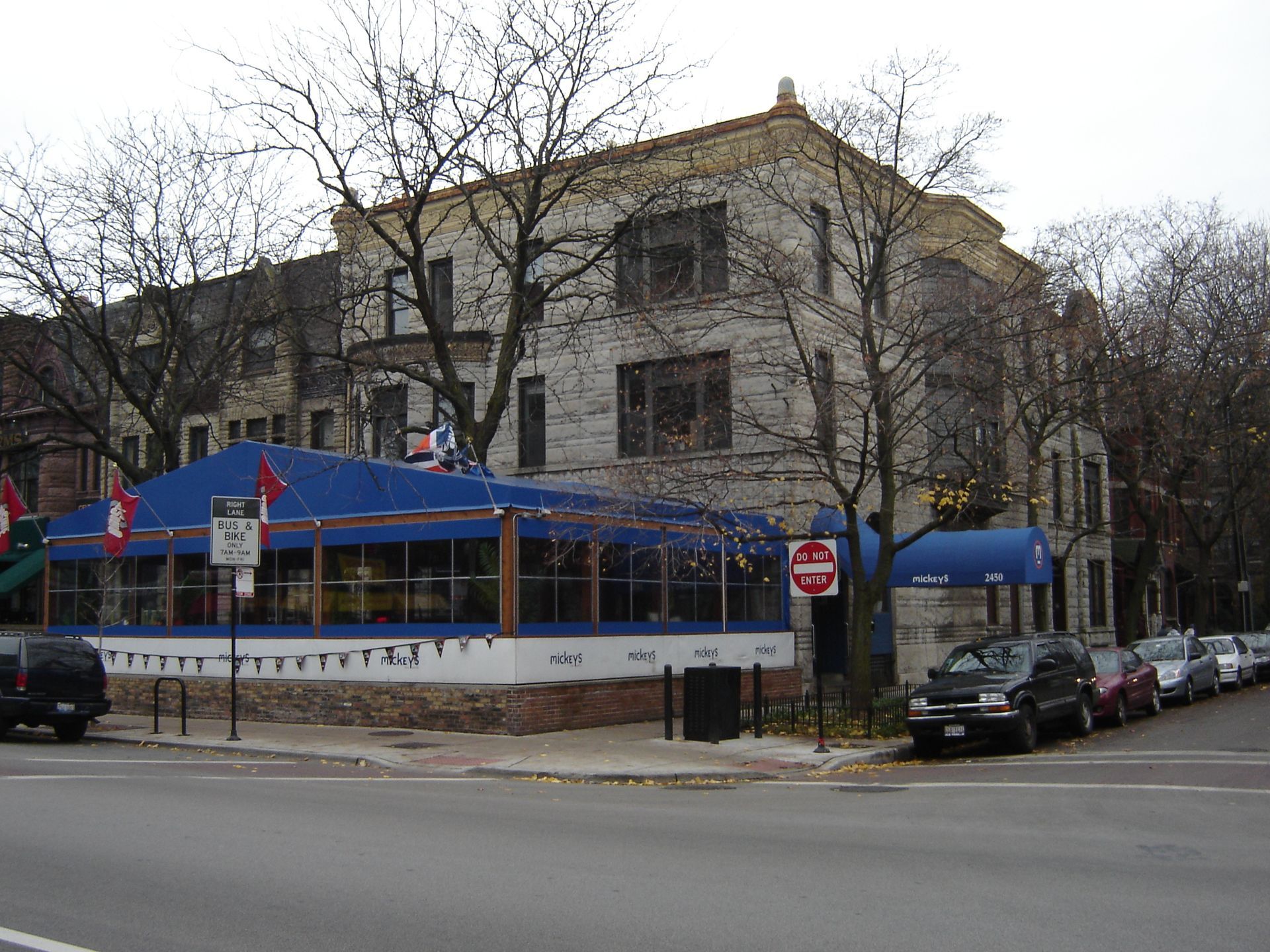 A building with a blue awning and a do not enter sign