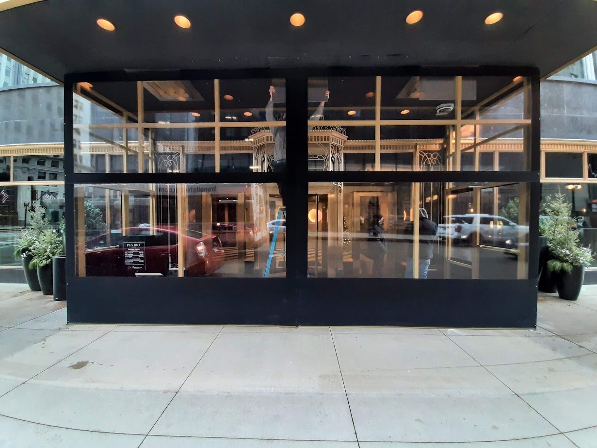 A building with a lot of windows and a car parked in front of it