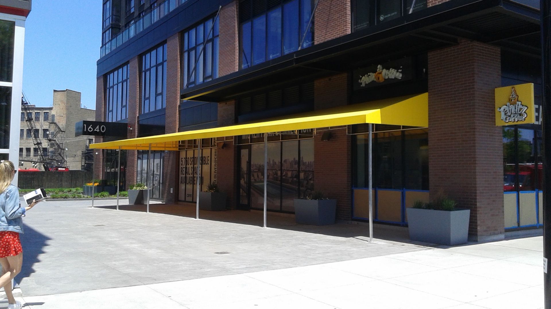 A yellow awning is on the side of a building